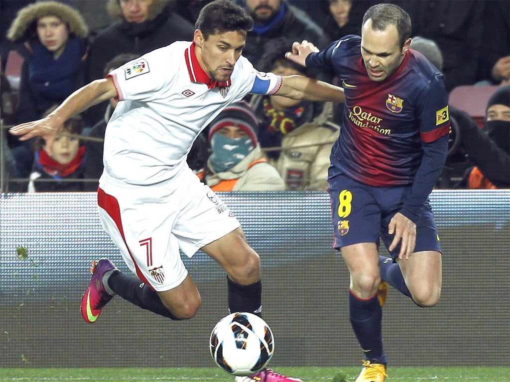 Jesus Navas takes on Andres Iniesta of Barcelona in his Sevilla days