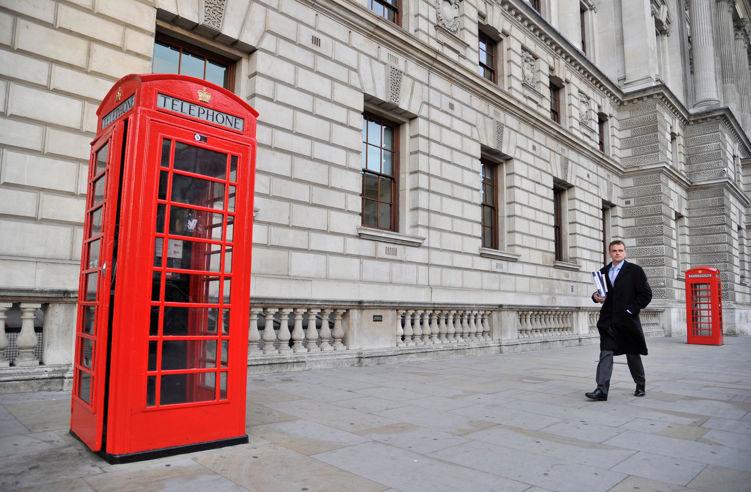 A worker walks past the Treasury building in Whitehall