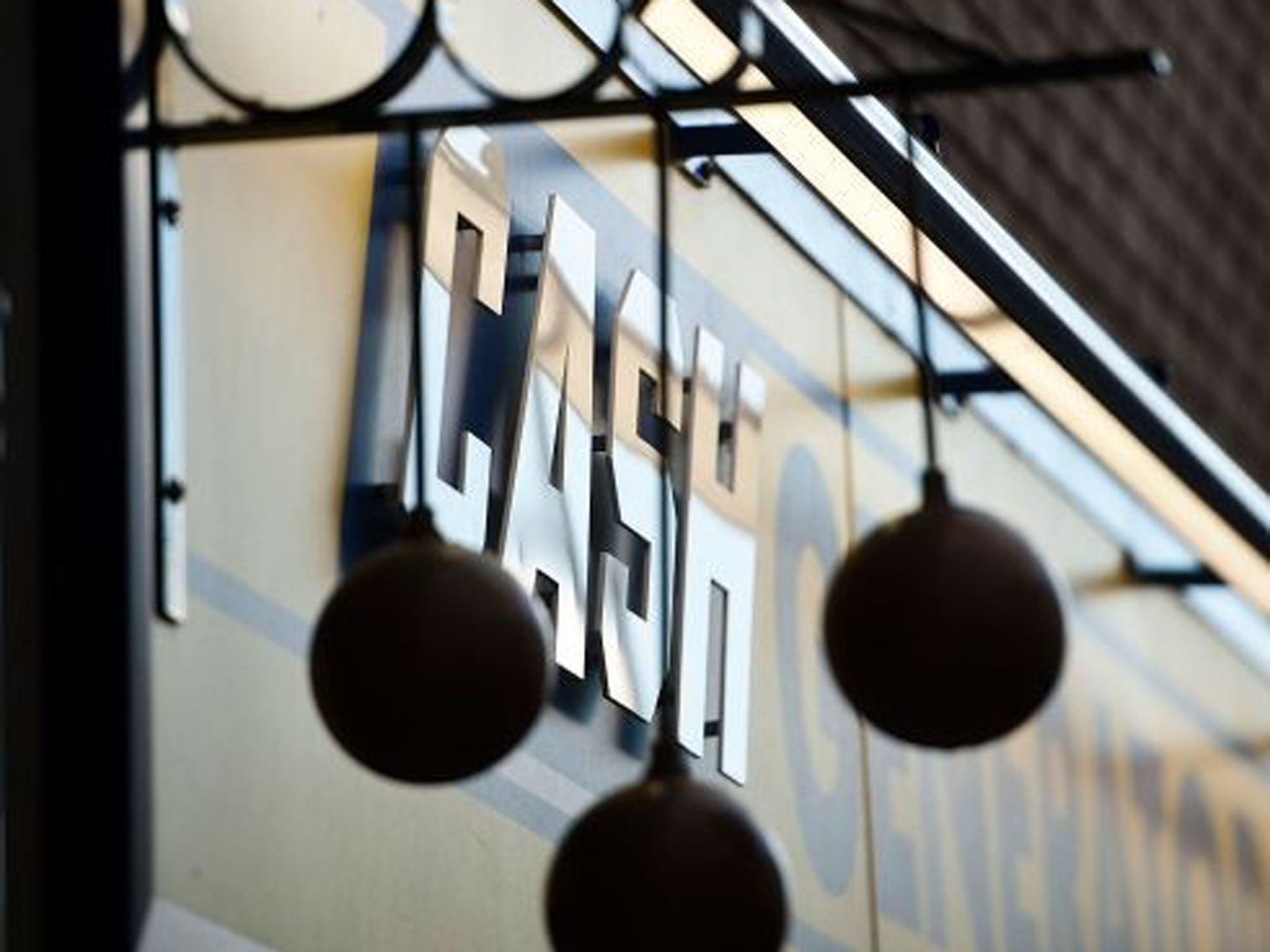 The Pawnbroker logo hangs outside a pawn shop in Walthamstow in London, England