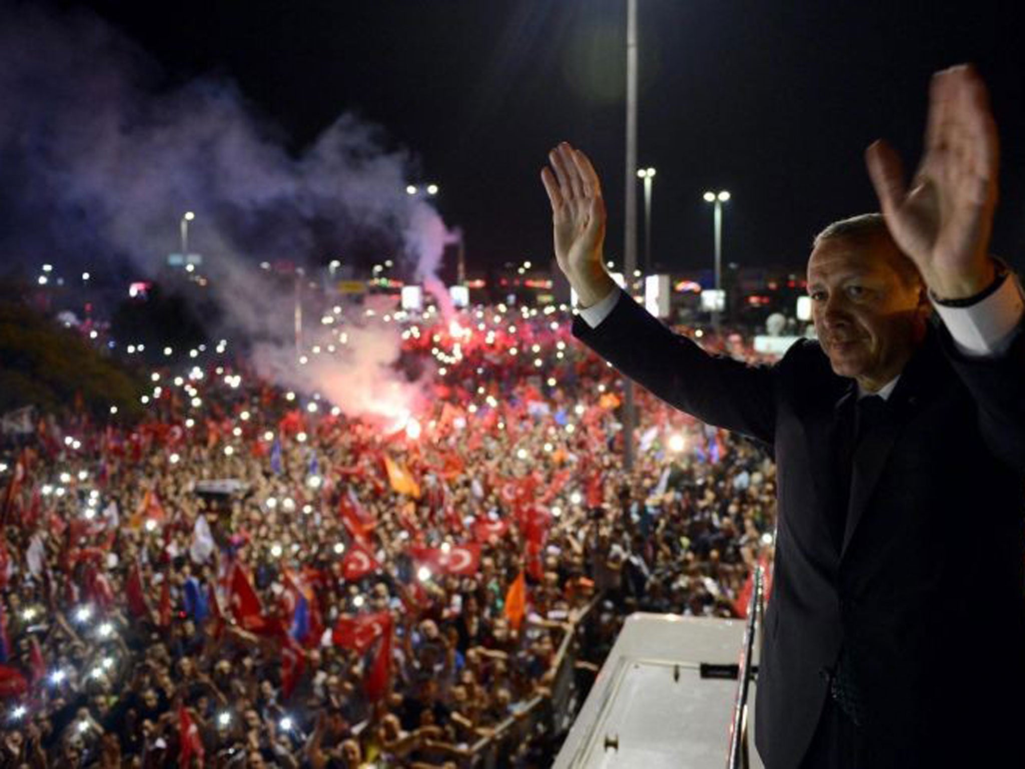 Turkish Prime Minister Recep Tayyip Erdogan greets his supporters following his arrival after a four day trip to North African countries at Ataturk Airport in Istanbul, Turkey