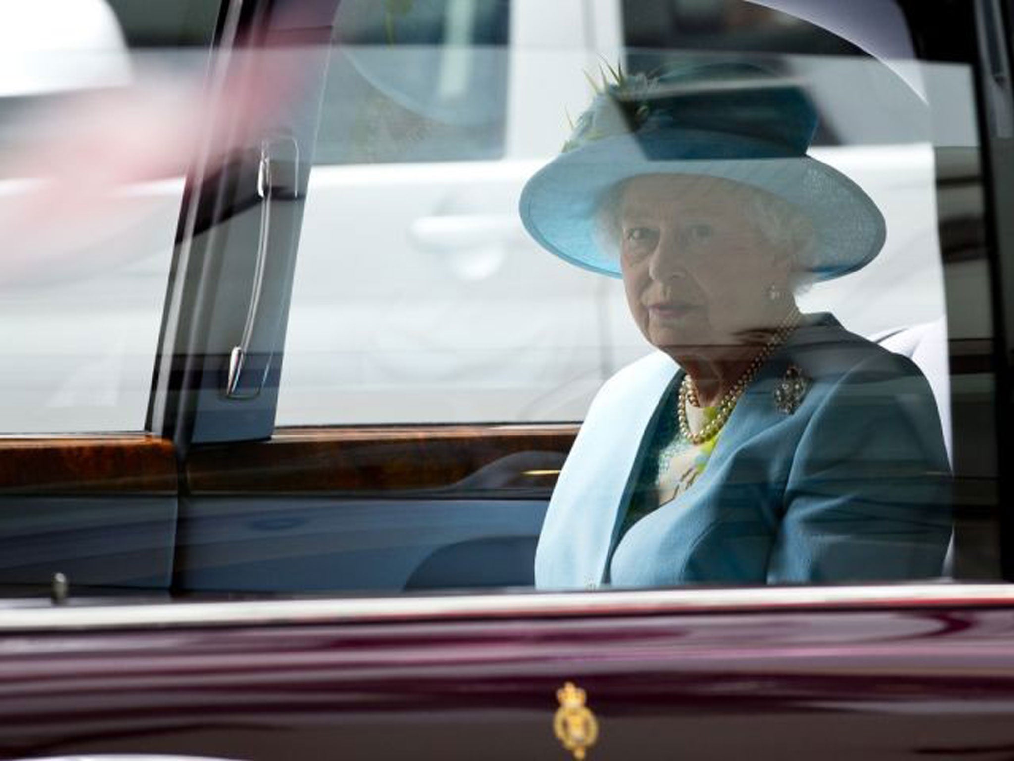 Britain's Queen Elizabeth II sits in her car after officially opening the headquarters of the British Broadcasting Corporation's new Broadcasting House in central London