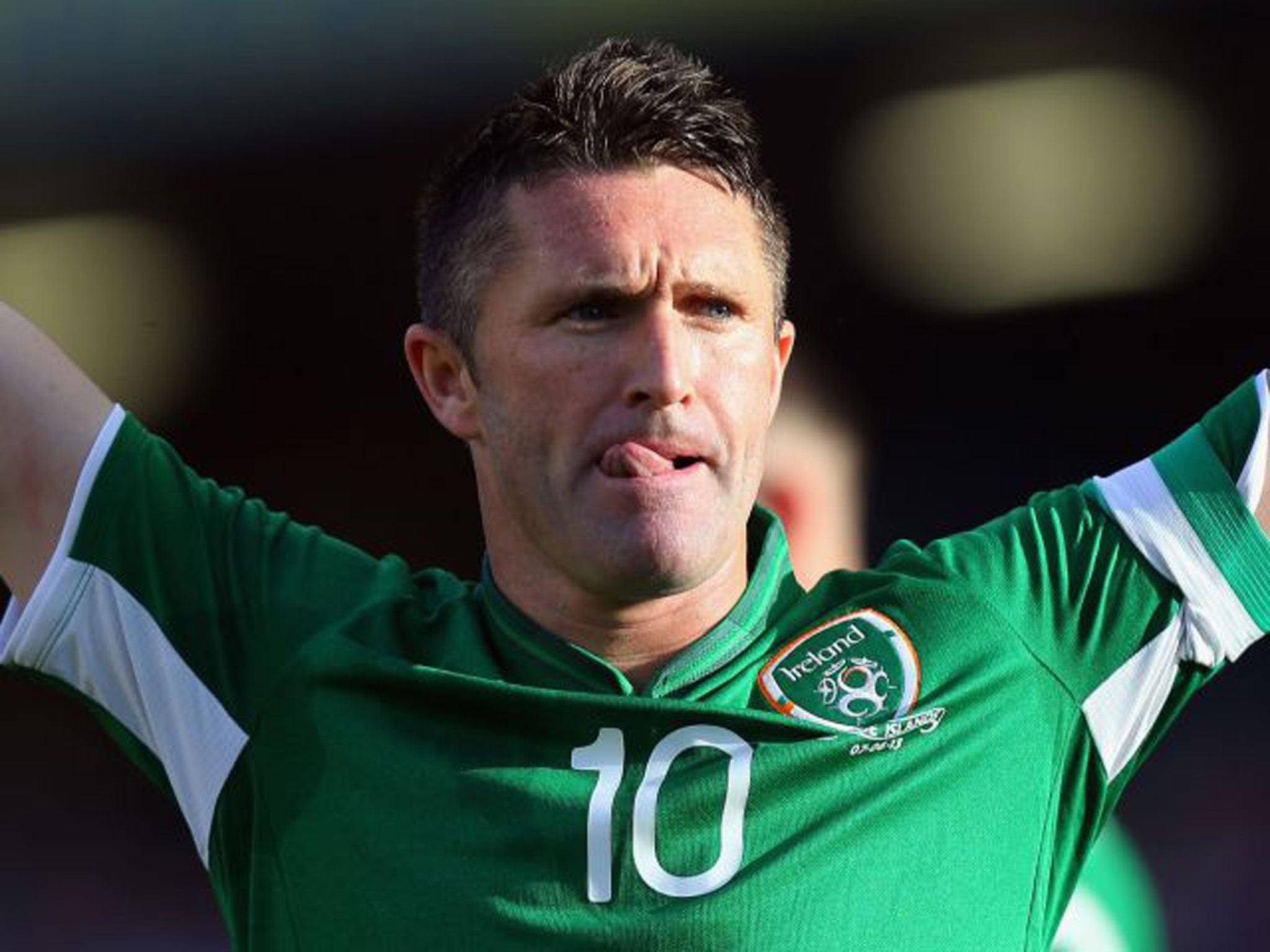 Robbie Keane celebrates his hat-trick on his 126th cap