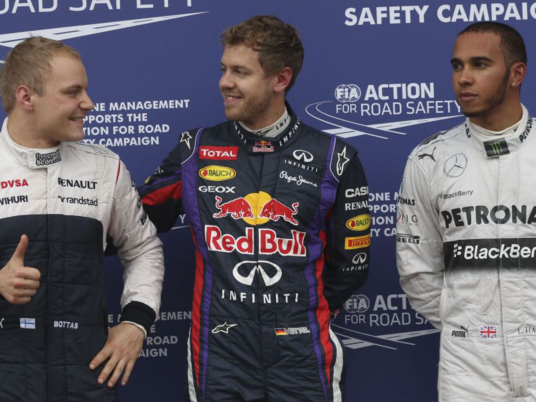 Red Bull driver Sebastian Vettel of Germany, center, pole position, smiles to rookie Williams driver Valtteri Bottas, left, of Finland, third fastest time, and Mercedes driver Lewis Hamilton who finished second