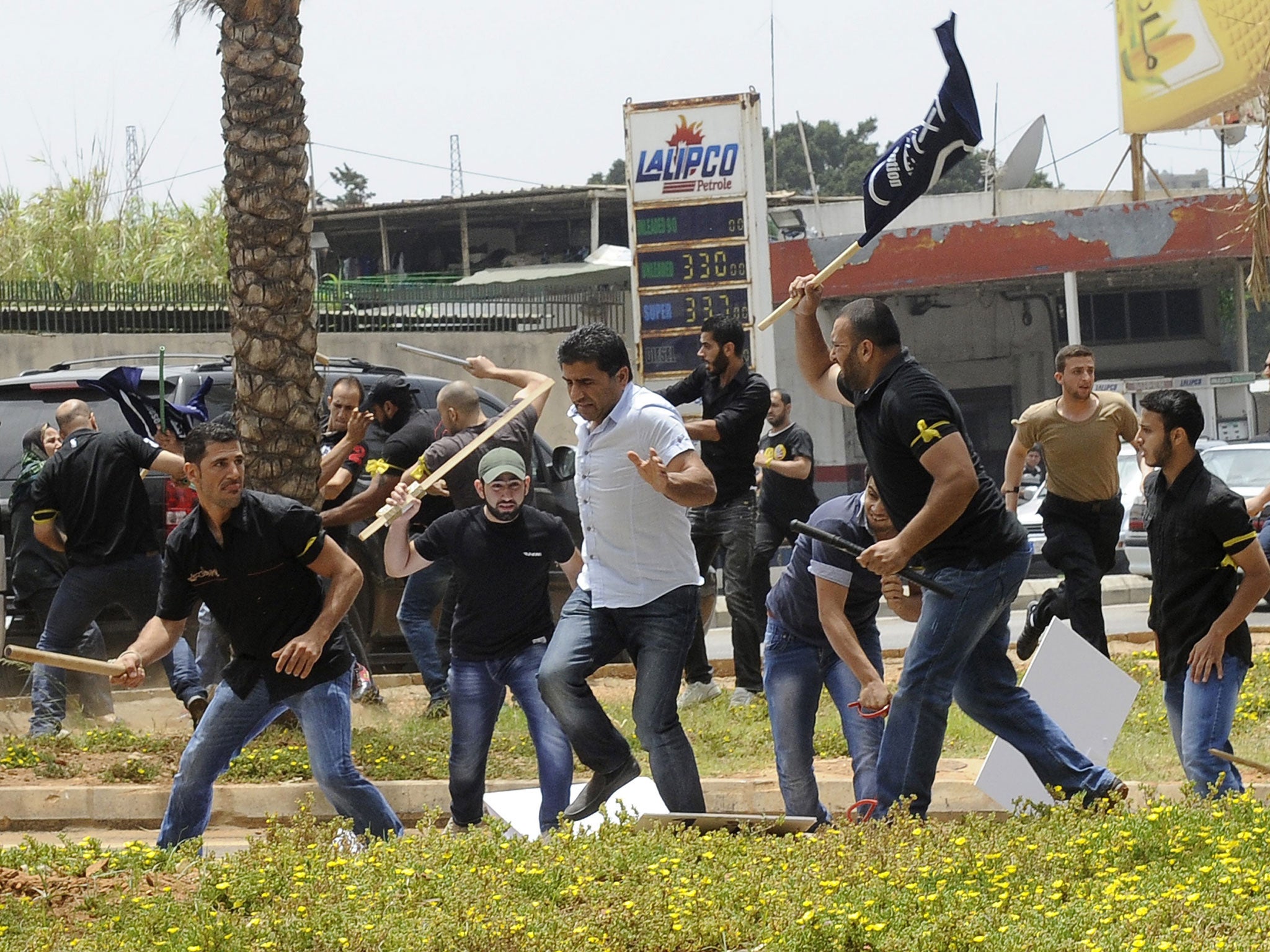 A protester flees from security men at the embassy