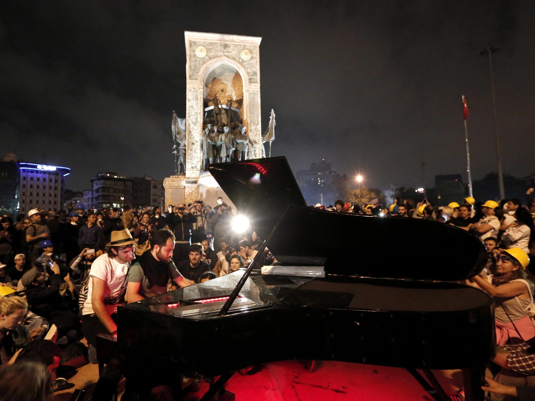 German pianist Klavier Kunst (L) performs with an unidentified activist at Taksim Square in Istanbul, Turkey