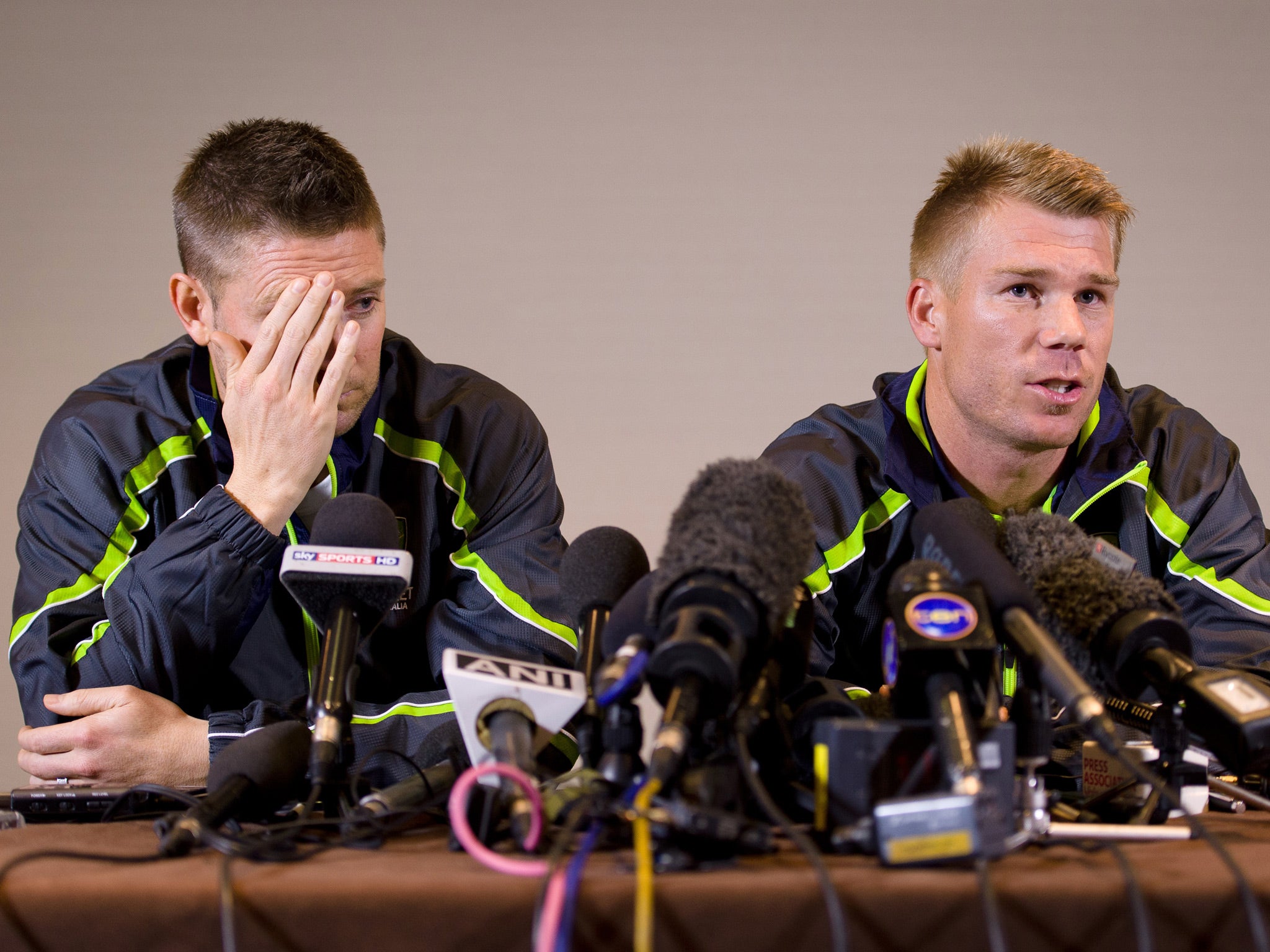 Australian cricketer David Warner (R) answers questions from the media as he sits beside team captain Michael Clarke during a press conference in central London