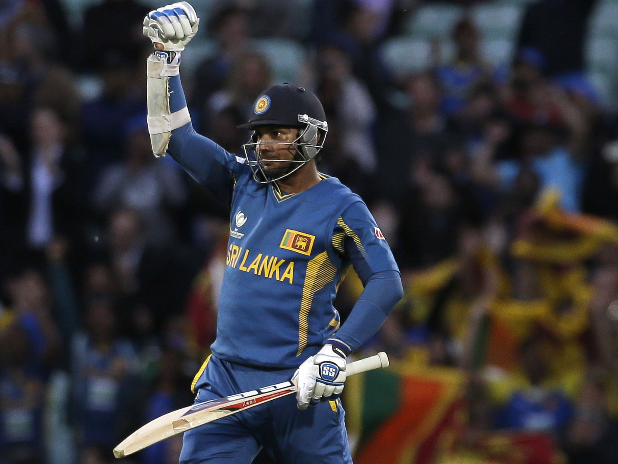 Sri Lanka's Kumar Sangakkara punches the air after he hit the winning runs to defeat England in their ICC Champions Trophy cricket match at the Oval cricket ground in London