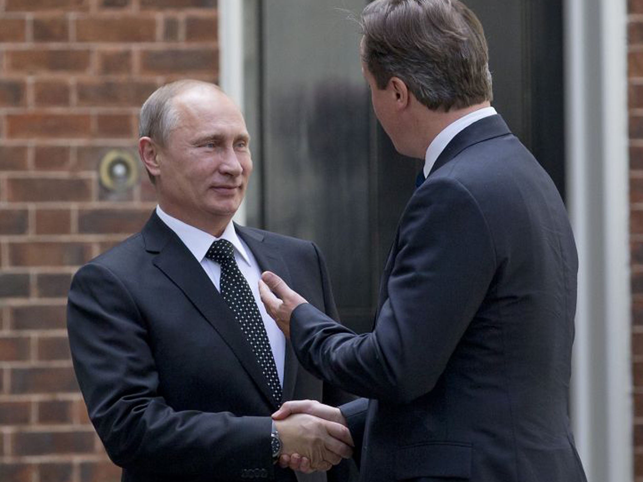 Prime Minister David Cameron greets Russian President Vladimir Putin in front of the cameras ahead of their meeting at Downing Street (Justin Tallis/AFP/Getty Images)