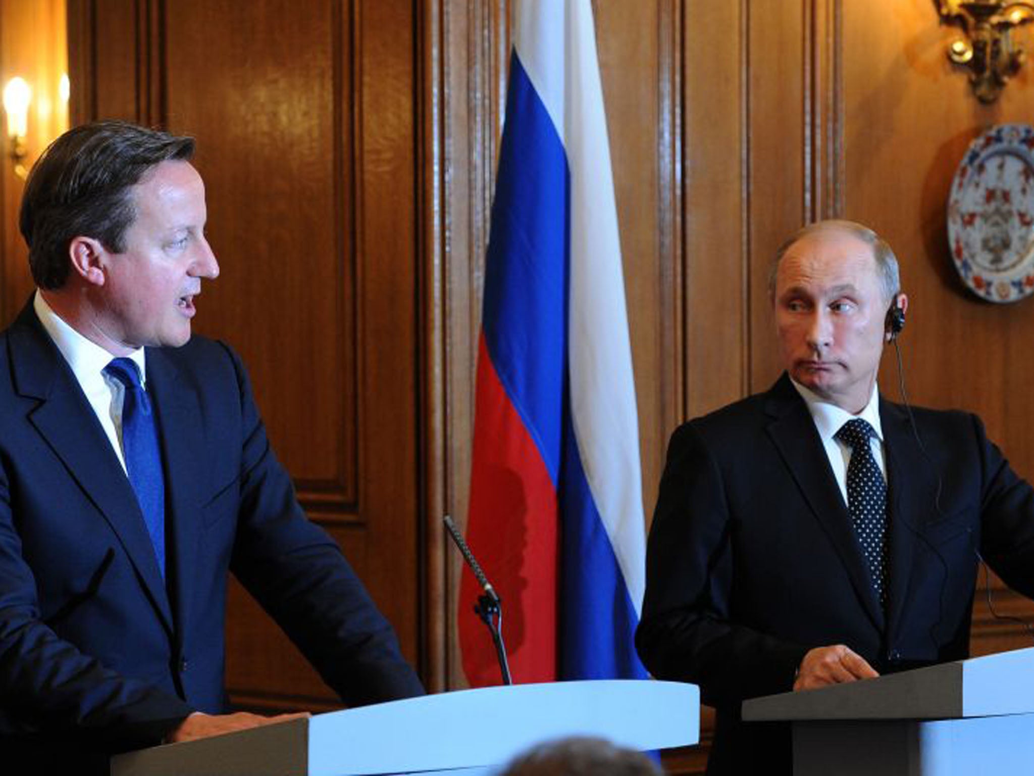 David Cameron, left, and President Putin at the press conference following their meeting. President Putin expressed an emphasis on the fact that Russia was acting in accordance with international law in arming what he said was the “legitimate government” in Syria (Anthony Devlin/PA)