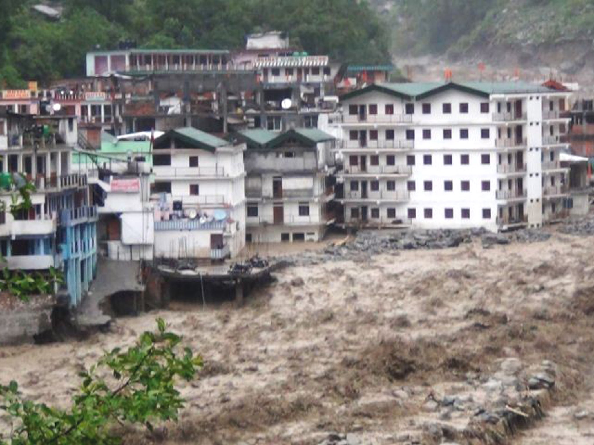 Torrential downpours in northern states wash away roads, buildings and vehicles