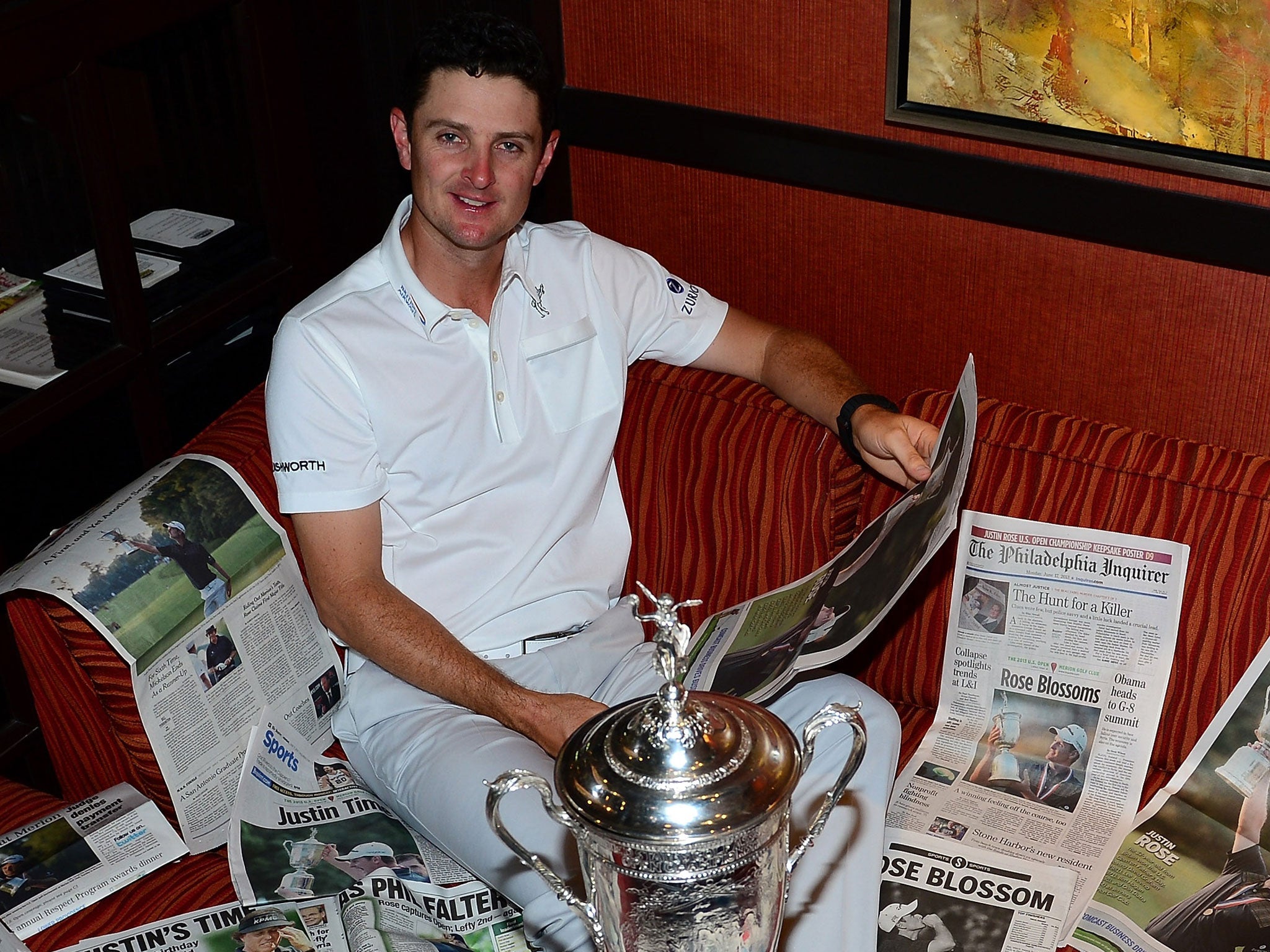 Justin Rose has a look at the papers the morning after his US Open triumph