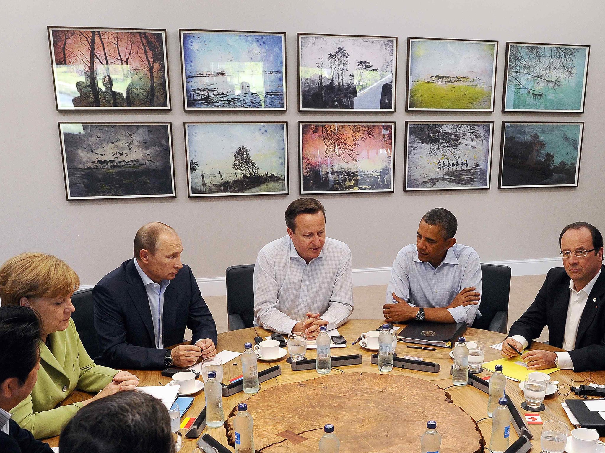 18 June 2013: Britain's Prime Minister David Cameron (centre) sits with U.S. President Barack Obama (second right), French President Francois Hollande (right), Russian President Vladimir Putin (third left), German Chancellor Angela Merkel (second left), and other G8 leaders, during the second Plenary Session of the G8 Summit, at Lough Erne, near Enniskillen, in Northern Ireland