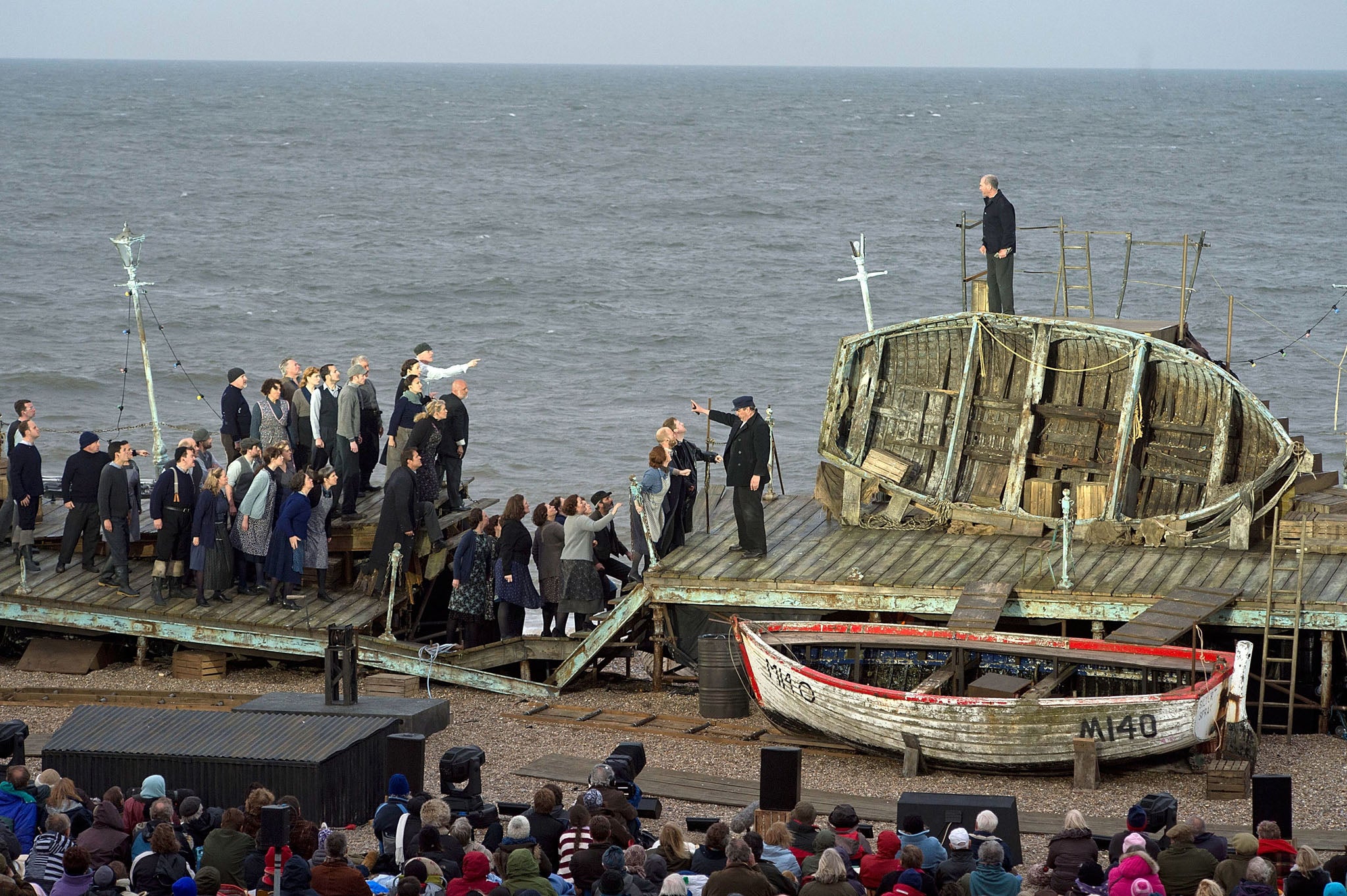Cast members take to the stage during the first performance of 'Grimes on the Beach', a production of Benjamin Britten's opera Peter Grimes at the Aldeburgh festival on June 17, 2013 in Aldeburgh, England. Tim Albery directs an outdoor realisation of 'Peter Grimes' that places the audience directly in its setting on the beach.