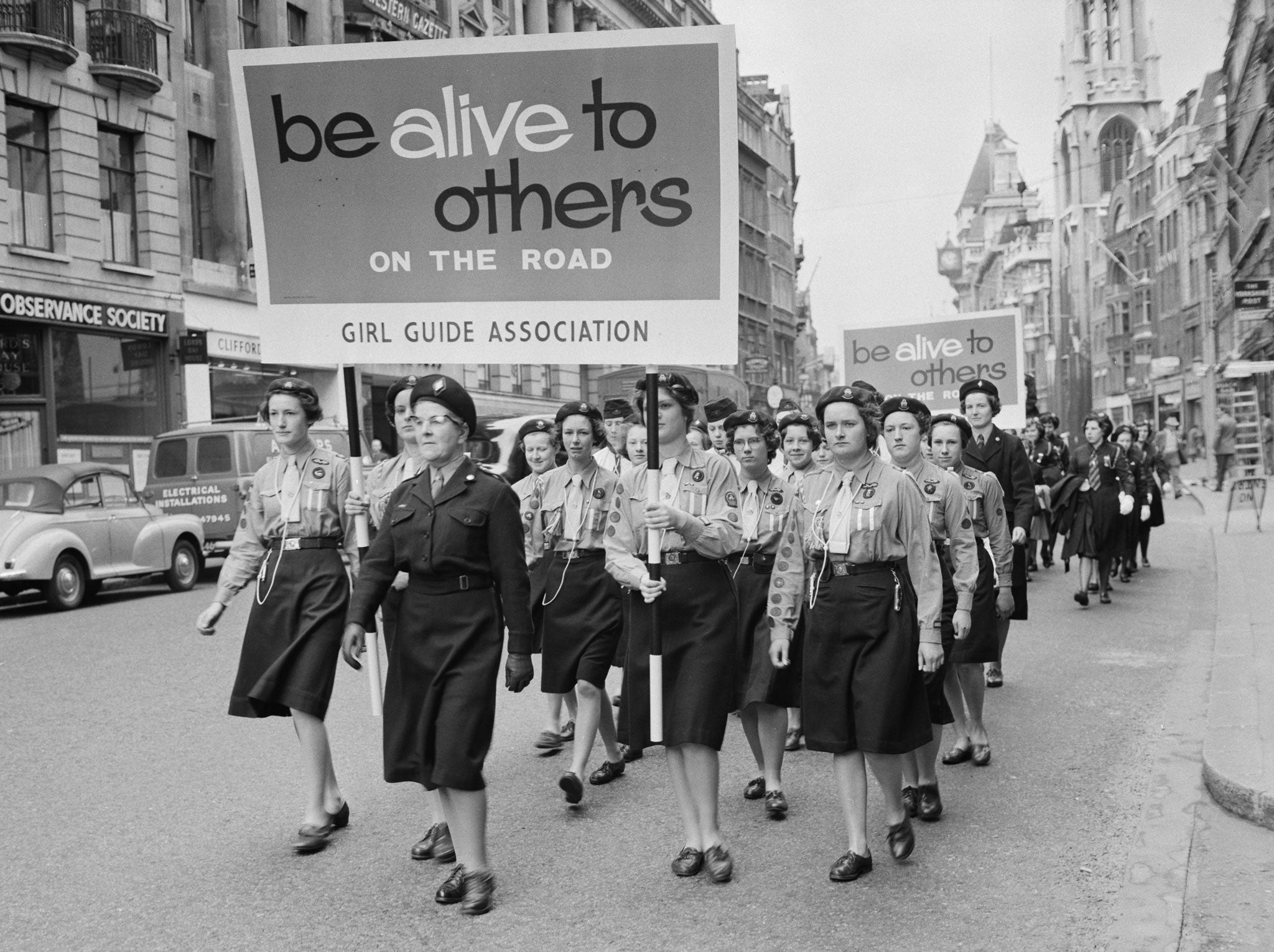 A troop of Girl Guides march down Fleet Street in London, as part of the new Road Safety Campaign organised by the Royal Society for the Prevention of Accidents, 22nd April 1961.