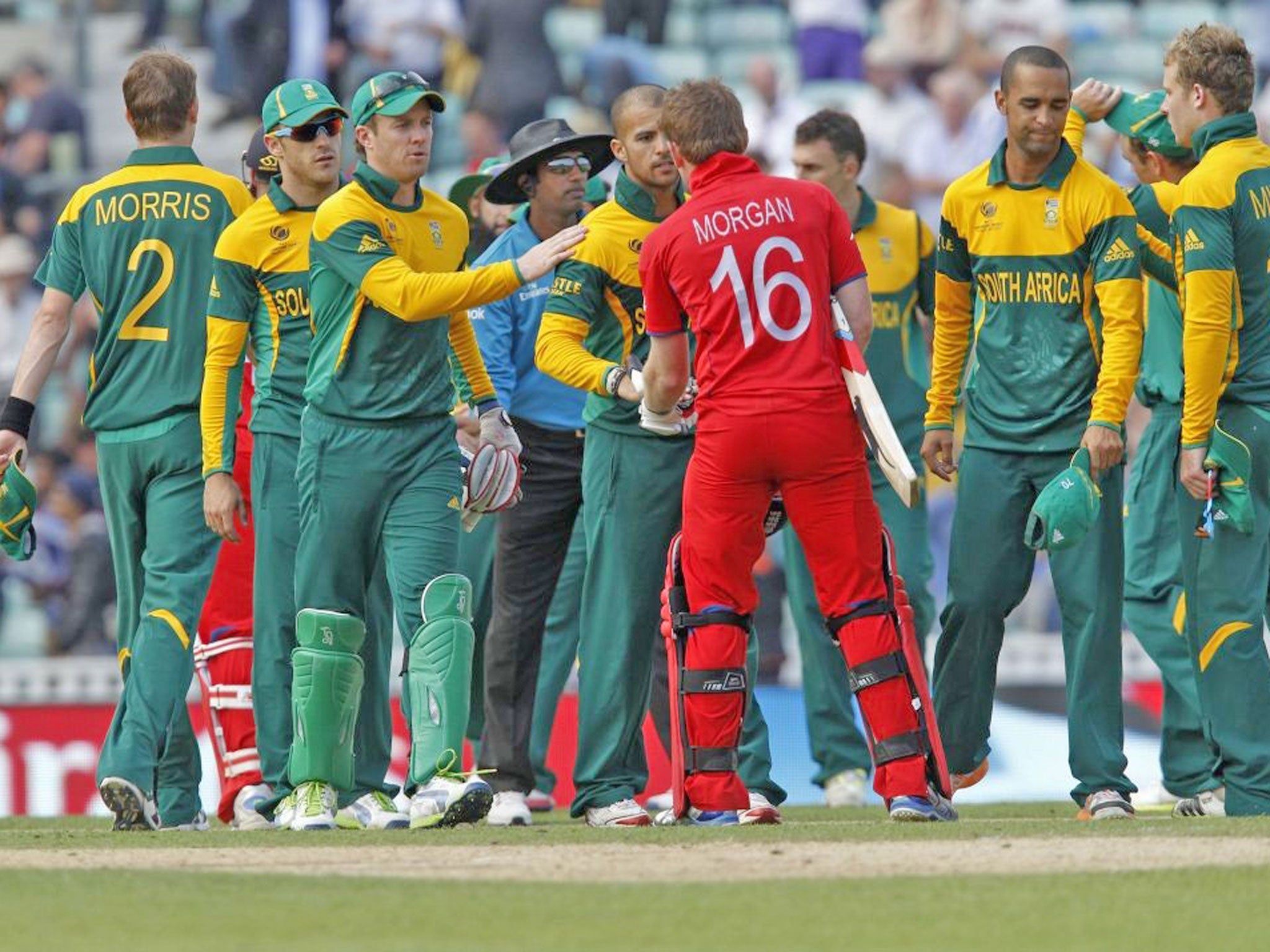 England's Eoin Morgan is congratulated by South African players following England's win