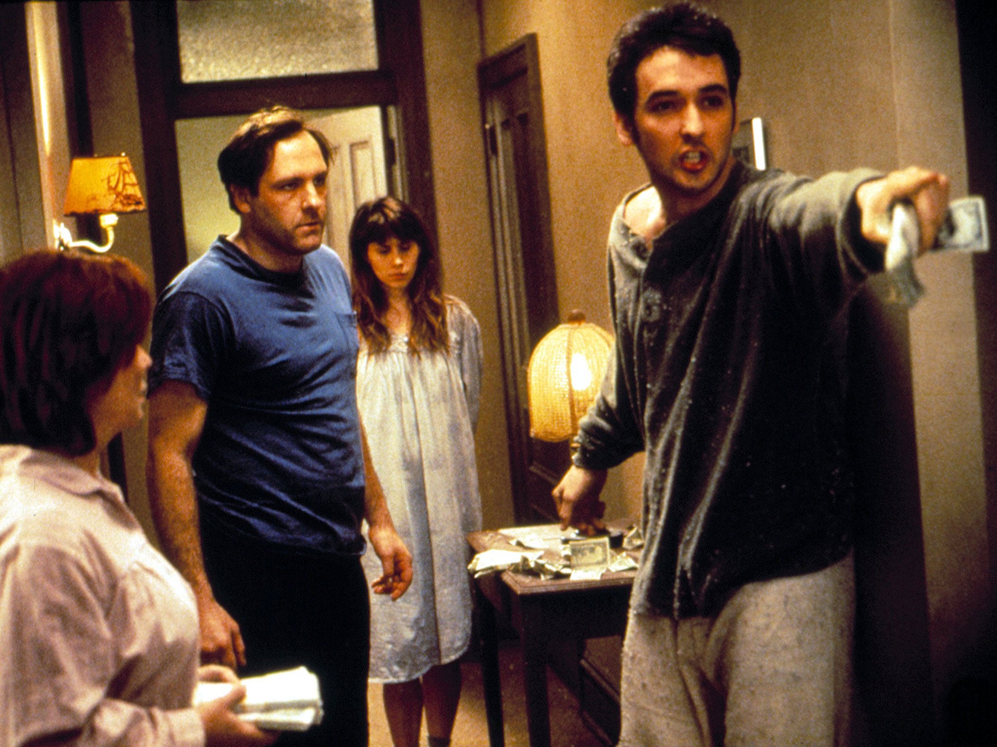 Opposite John Cusack (right) in 1993's crime comedy, 'Money for Nothing'