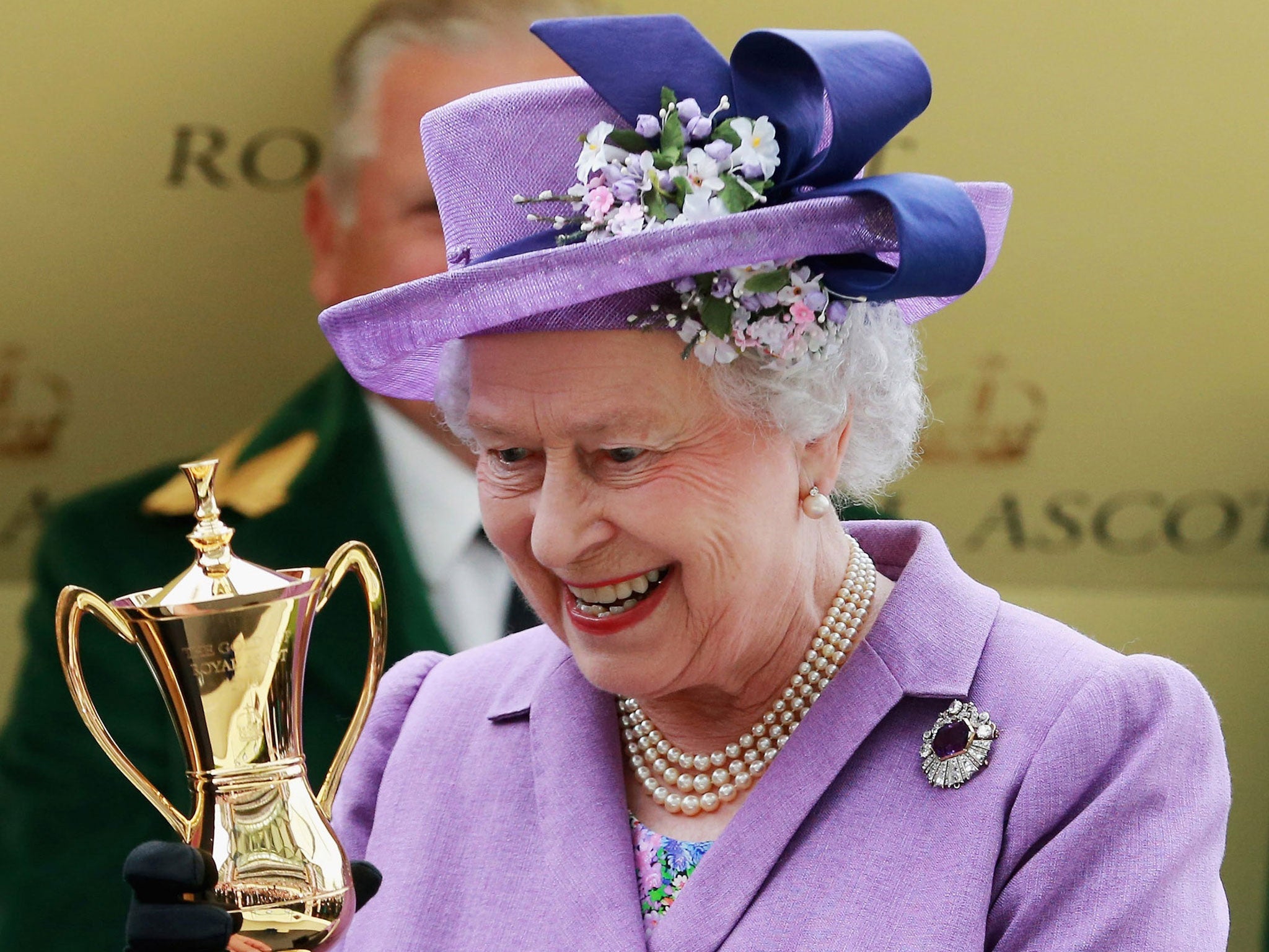 The Queen is handed the Gold Cup at Ascot yesterday after victory for her horse, Estimate