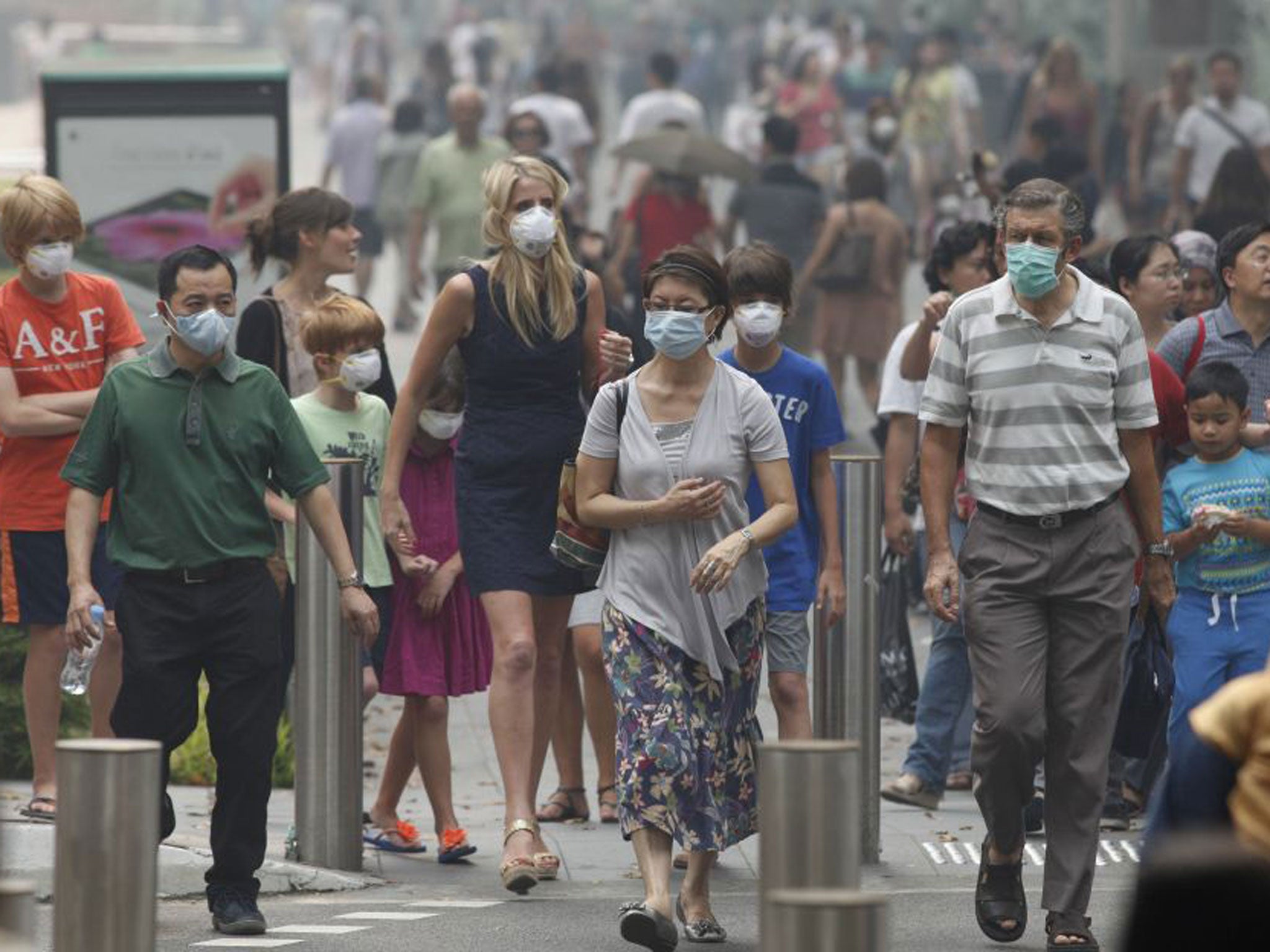 People cross a Singapore street