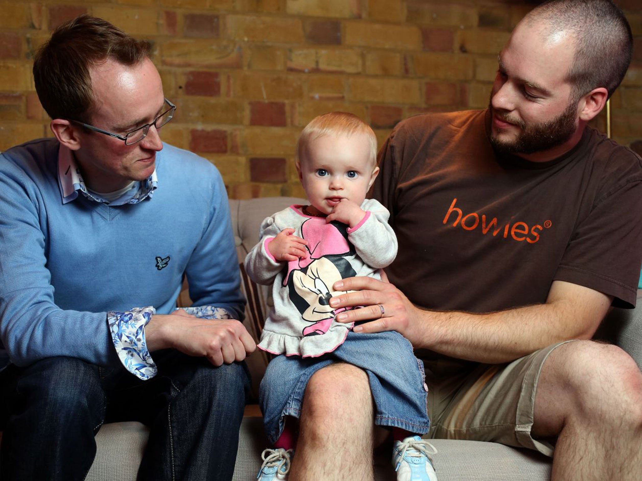 Childcare bloggers Darren Coleshill, left, and Lewis Lippiatt look after a friend’s daughter, nine-month-old Lexi-Arizona Knowles-Smith, at the Brit Mums Live blogging conference in London