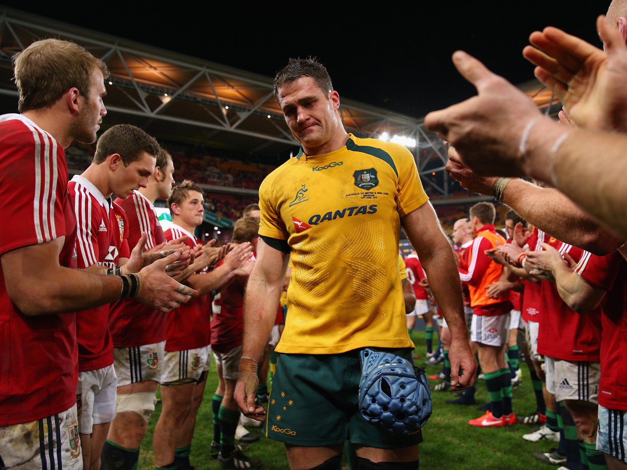 James Horwill is clapped off the field by the victorious Lions players