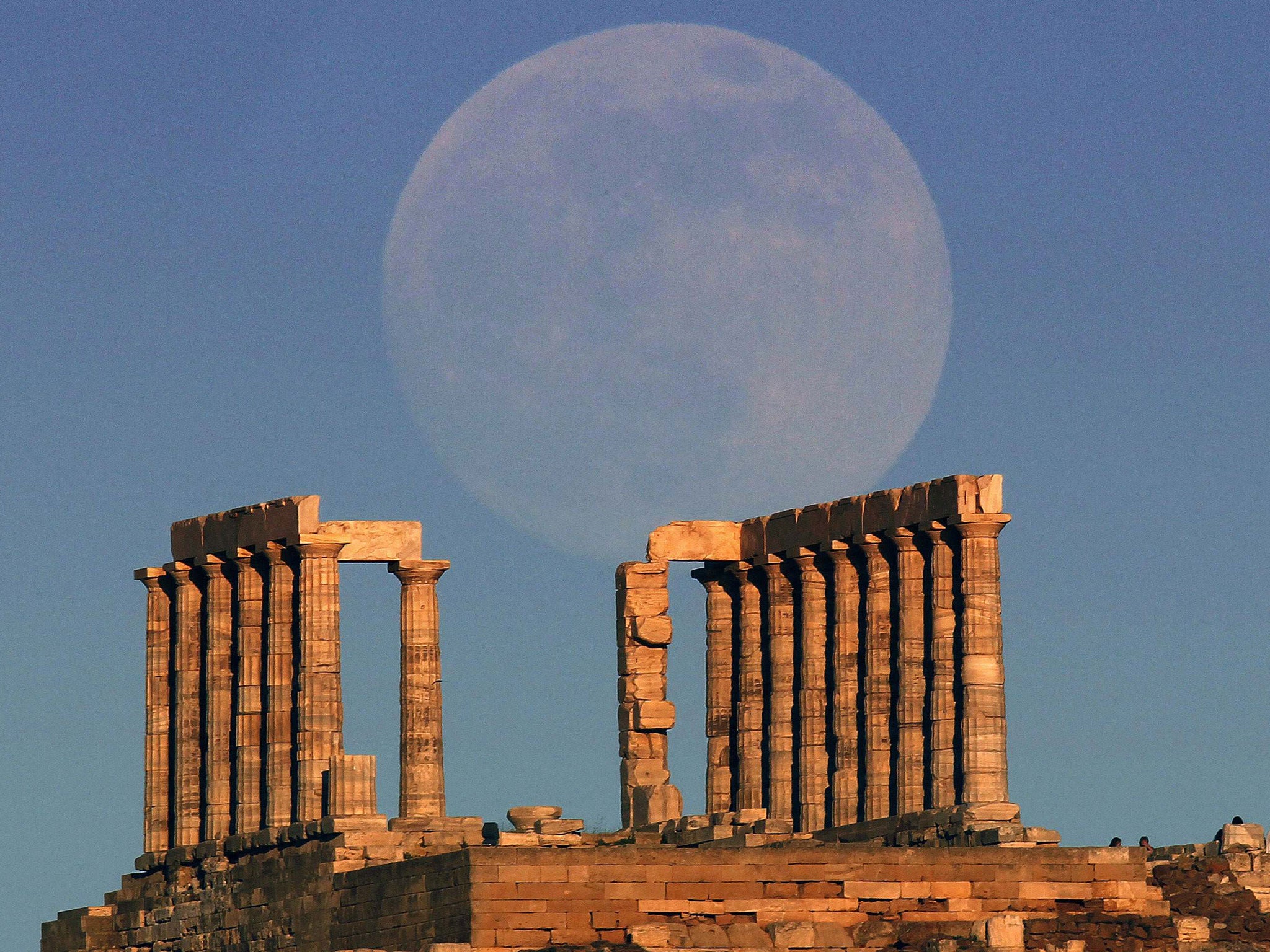 The ‘Supermoon’ rises over the temple of Poseidon, near Athens
