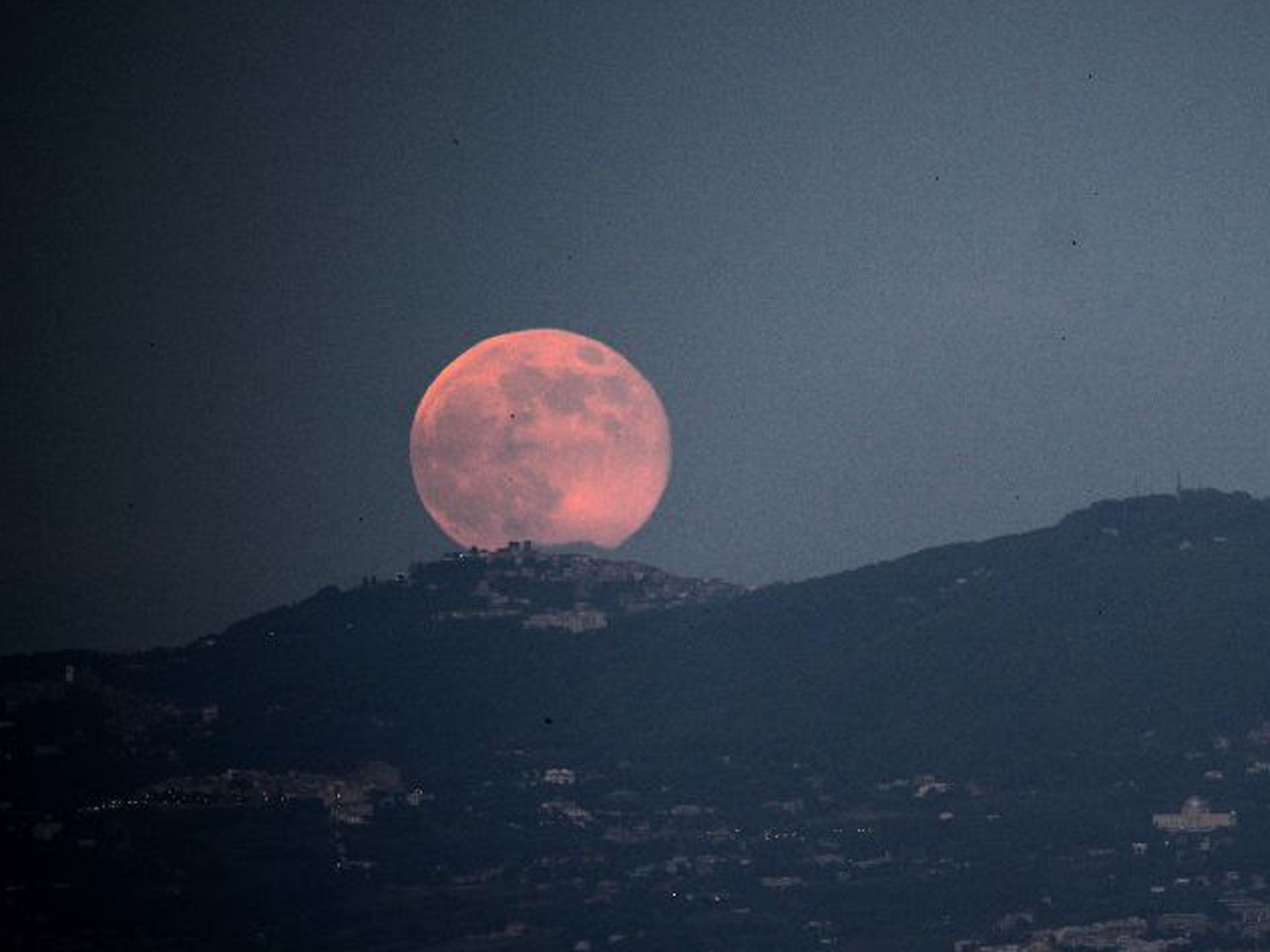 The moon rises over the city of Rome yesterday (Filippo Monteforte/AFP/Getty Images)