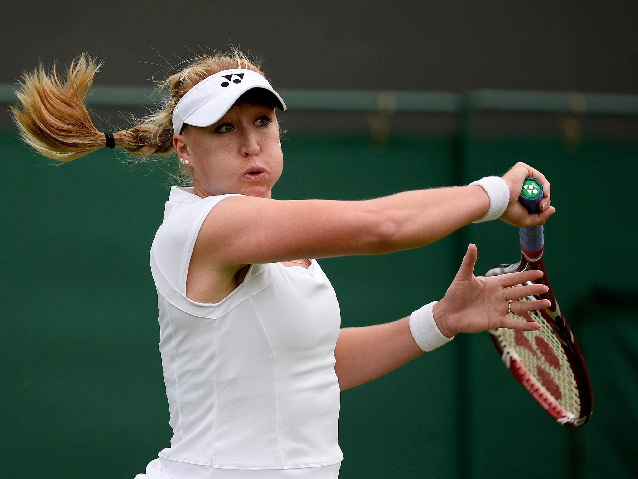 Elena Baltacha of Great Britain hits a forehand during the Ladies Singles match against Flavia Pennetta of Italy on day one at Wimbledon