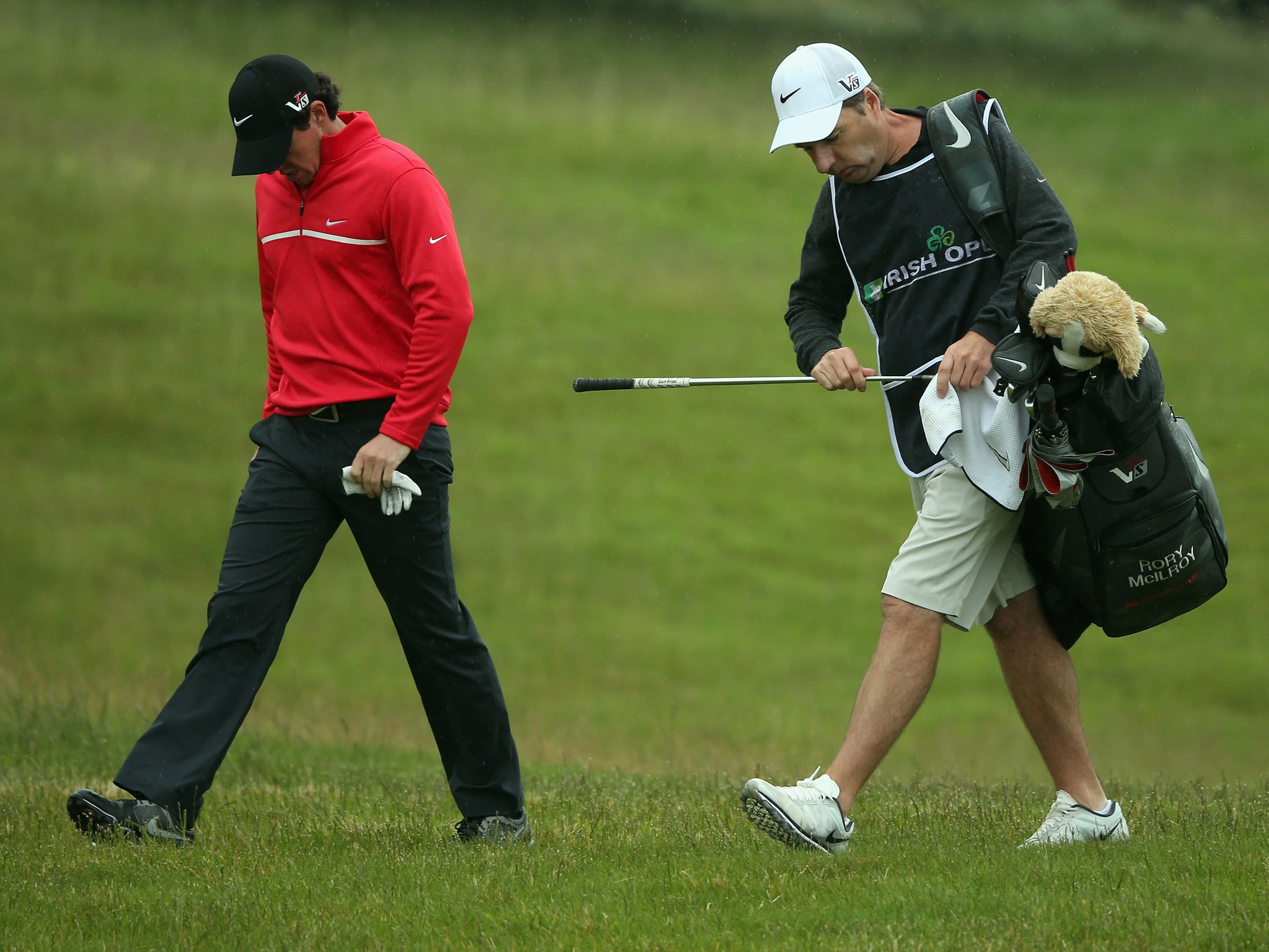 A dejected Rory Mcilroy and caddie JP Fitzgerald
