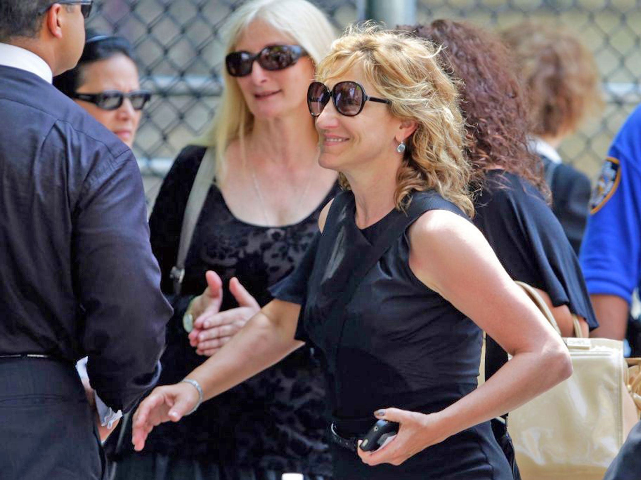 Actress Edie Falco leaves the funeral service of James Gandolfini, star of "The Sopranos," in New York's the Cathedral Church of Saint John the Divine