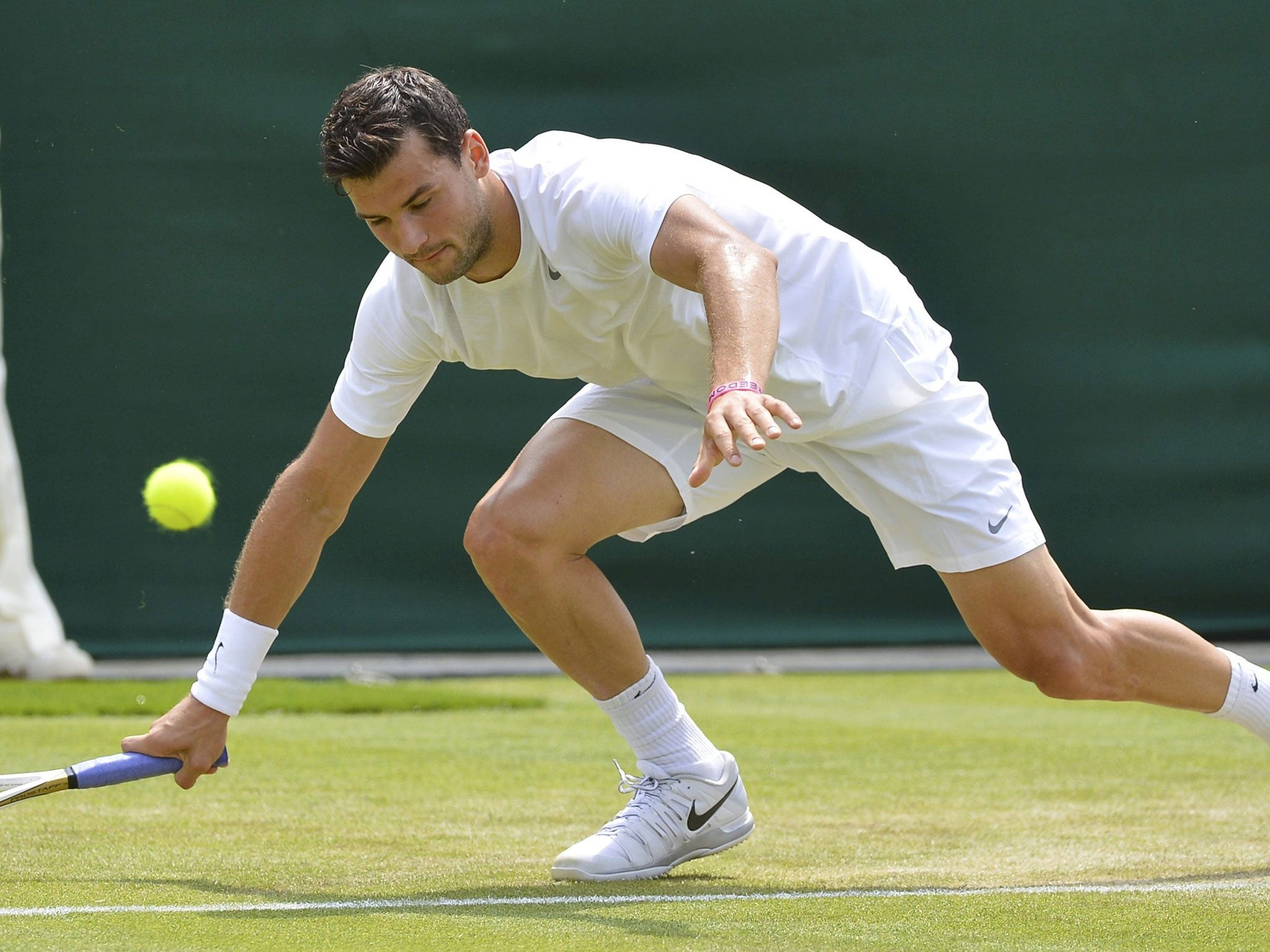 Grigor Dimitrov slips during his singles match with Grega Zemlja