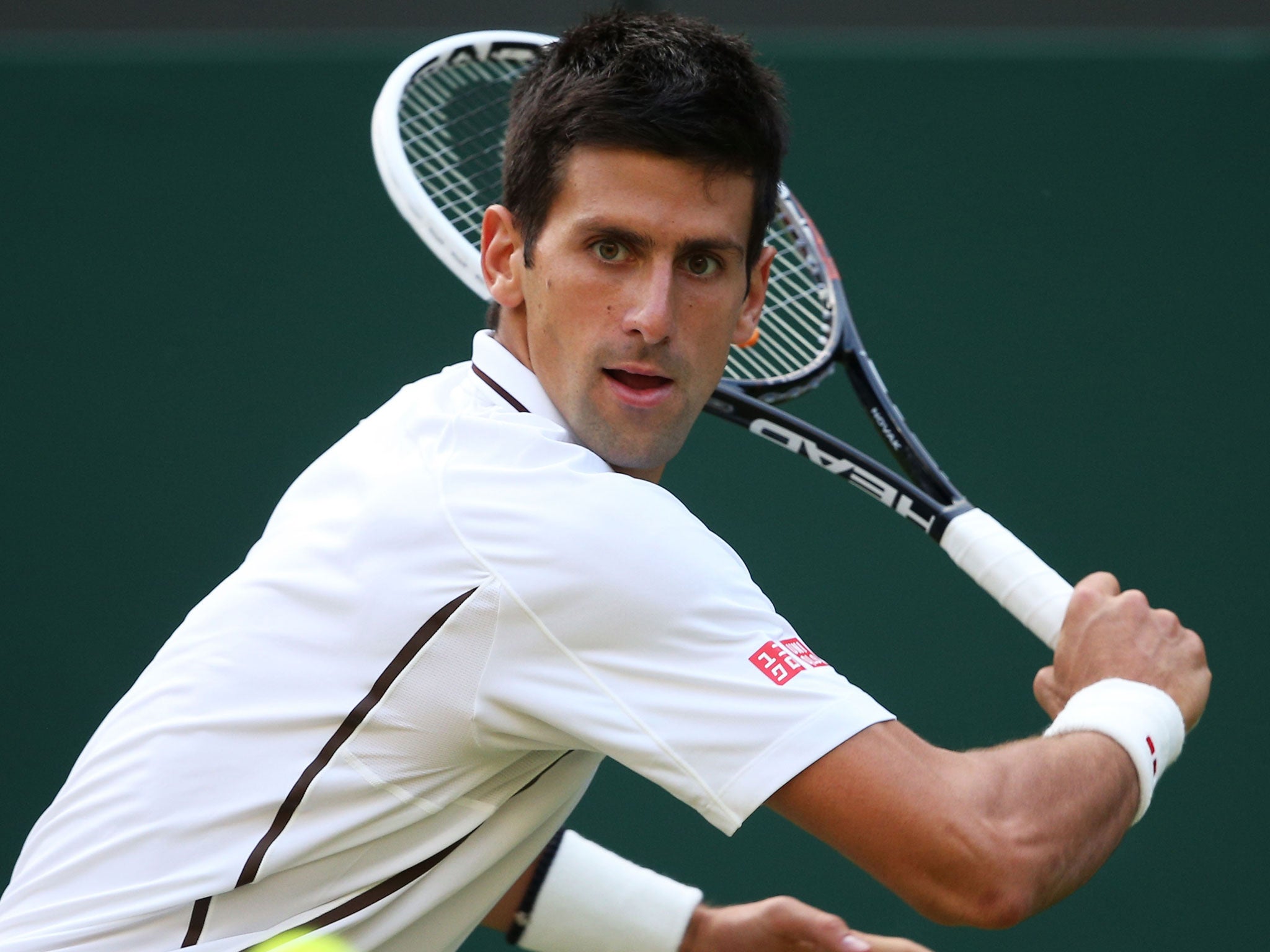 Novak Djokovic plays a backhand against Jeremy Chardy