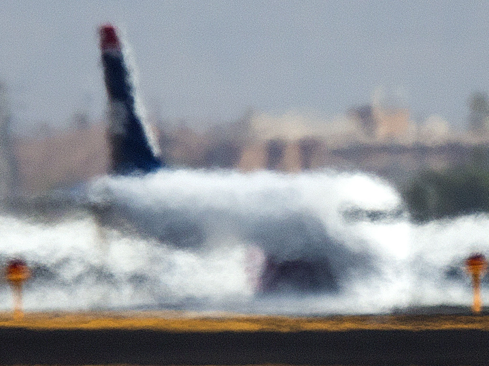 An airliner is distorted by the heat waves rising up from the north runway at Sky Harbor International Airport in Phoenix