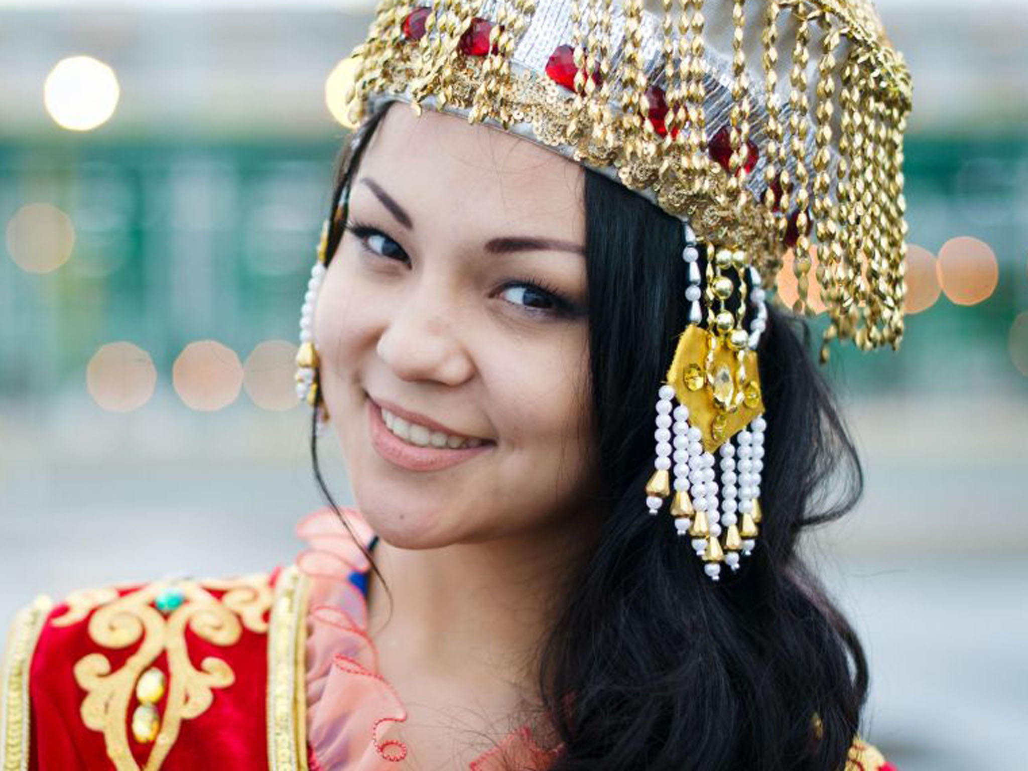 Part of the welcoming party for David Cameron was a woman in traditional Kazakh dress