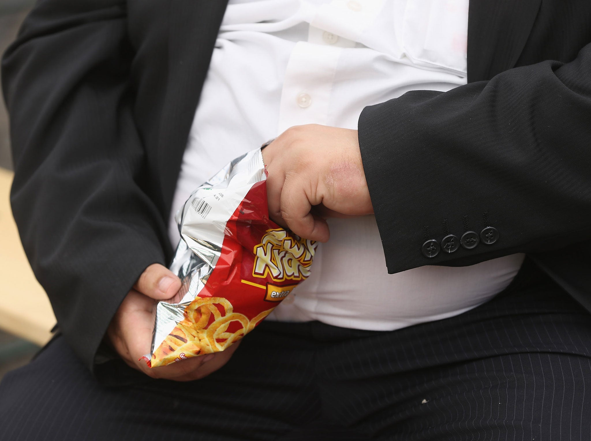 A man with a large belly eats junk food on May 23, 2013 in Leipzig, Germany.