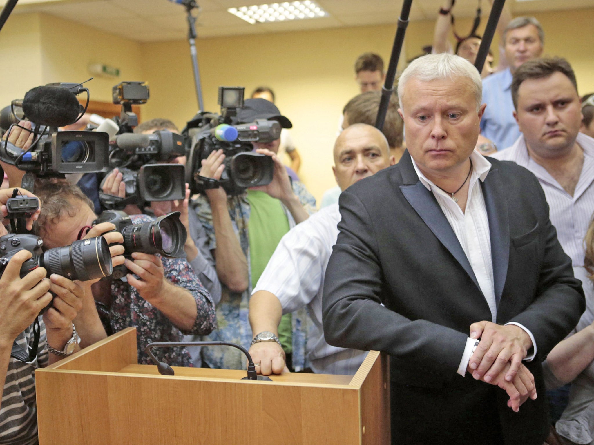 Alexander Lebedev is surrounded by media in the Moscow courtroom