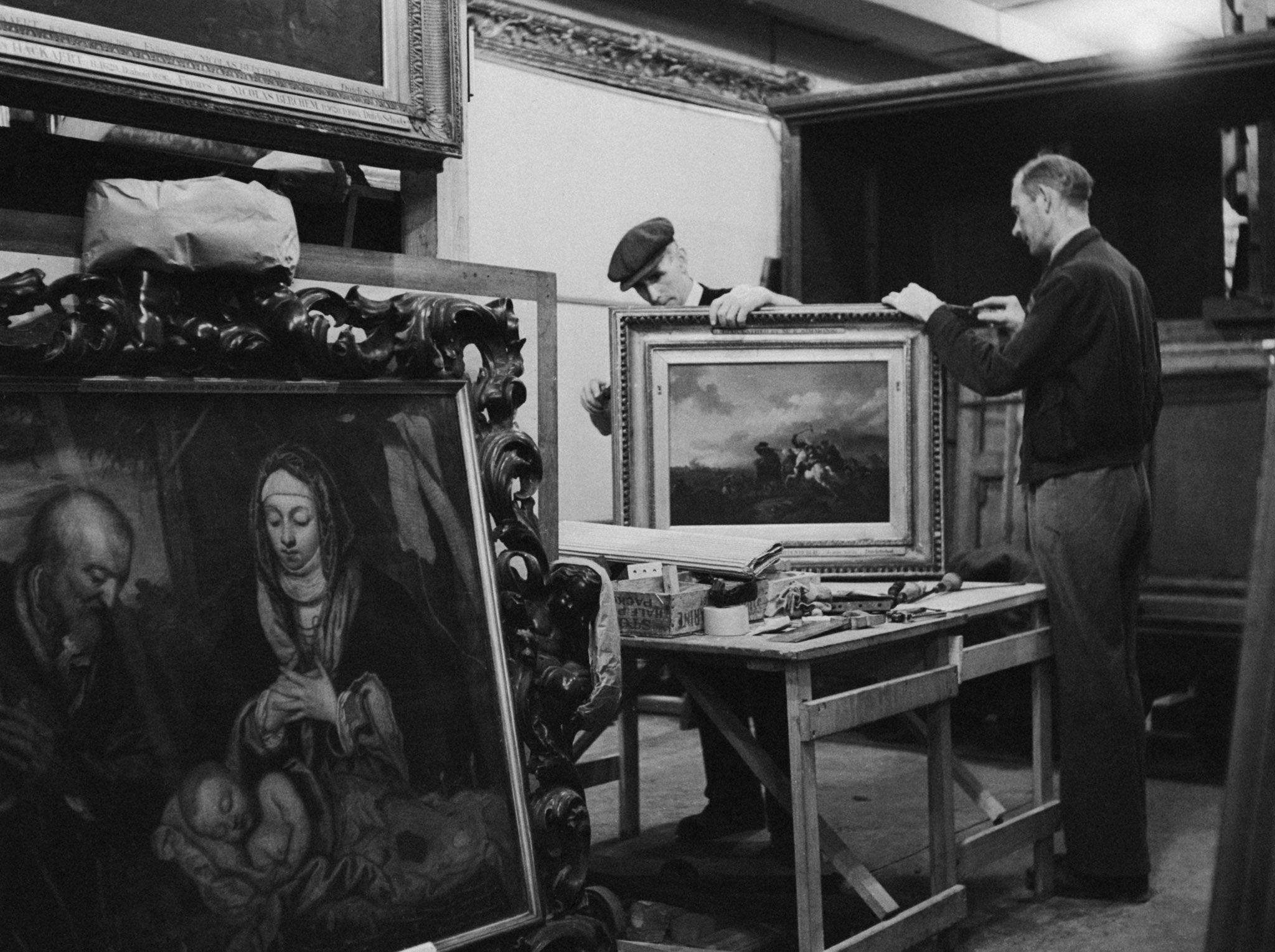 September 1942: A picture frame being repaired in a subterranean chamber at Manod Quarry, north Wales, where paintings from the National Gallery have been moved for safe keeping during wartime.