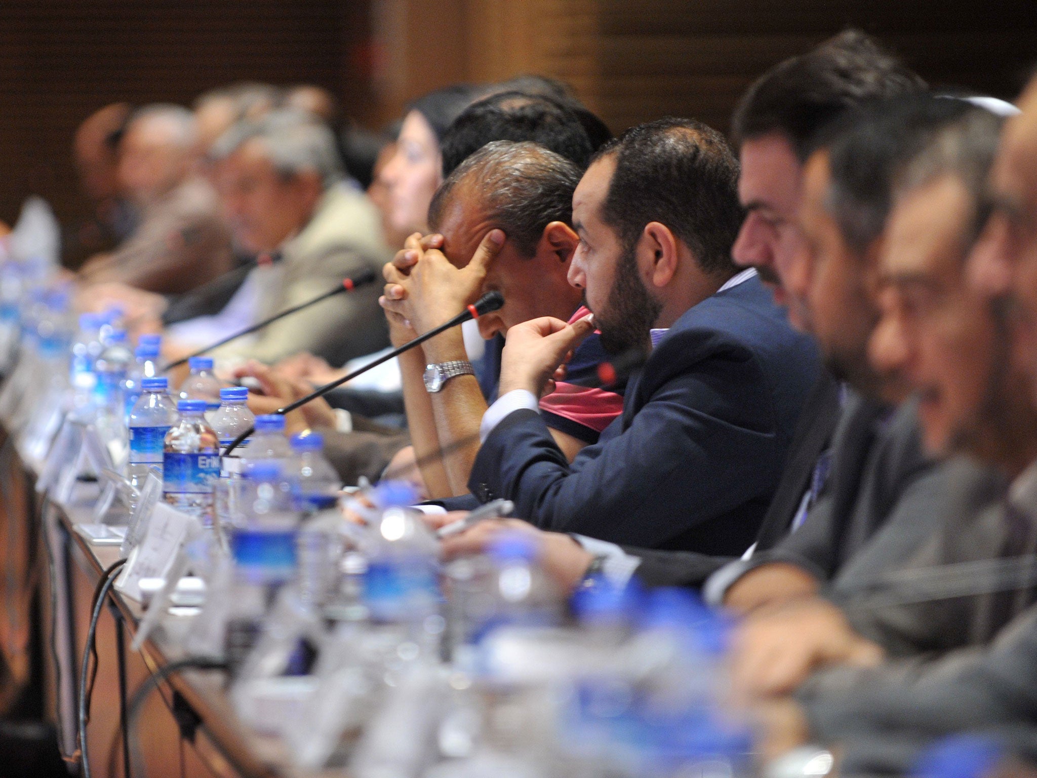 Members of the Syrian National Council (SNC) attend the National Coalition of Syrian Revolution and Opposition forces meeting