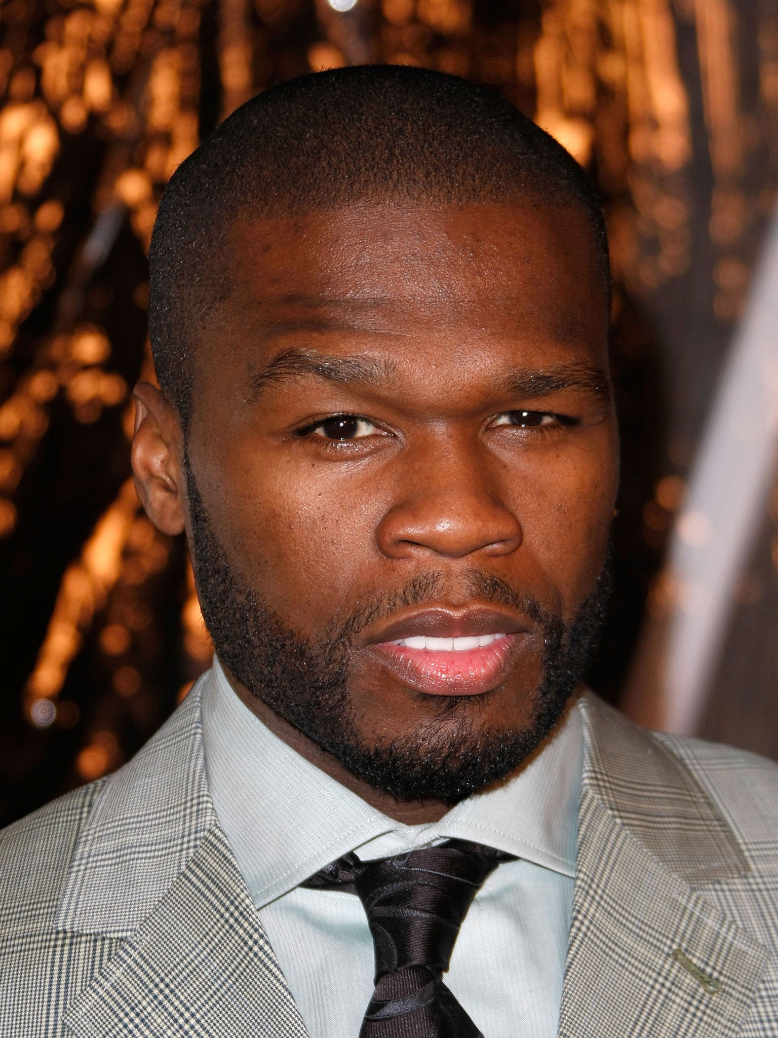 Rapper 50 Cent has been charged with attacking his ex-girlfriend