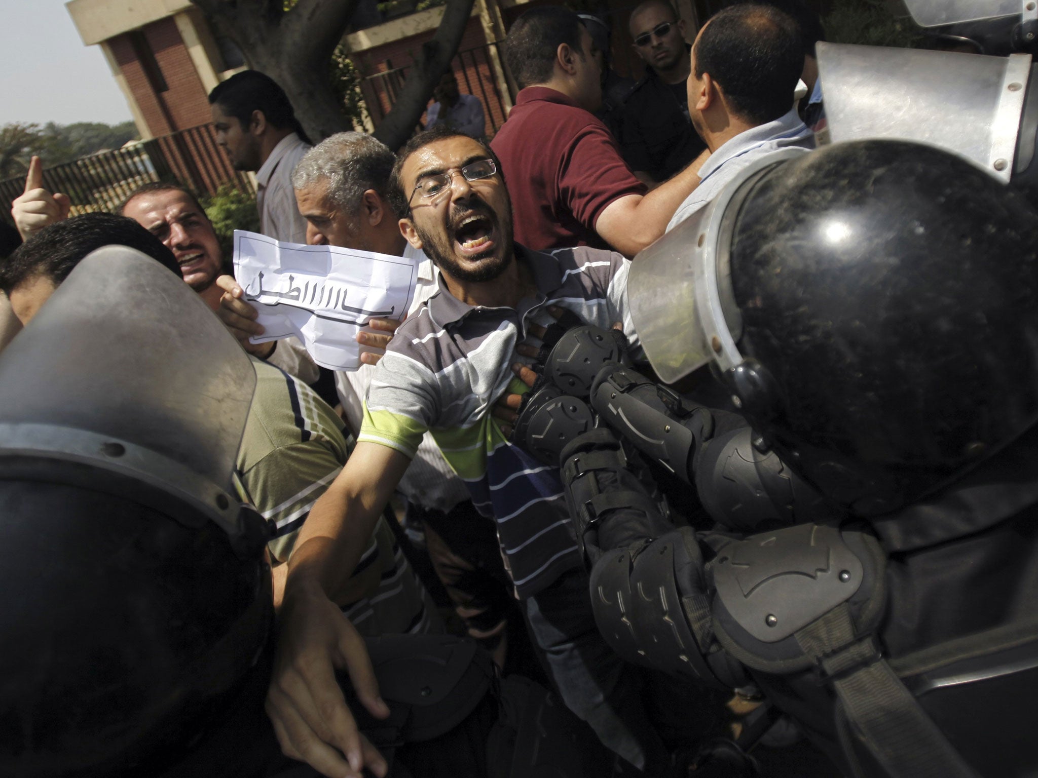 Members of the Muslim Brotherhood and supporters of ousted Egyptian President Mohamed Morsi shout slogans and clash with riot police