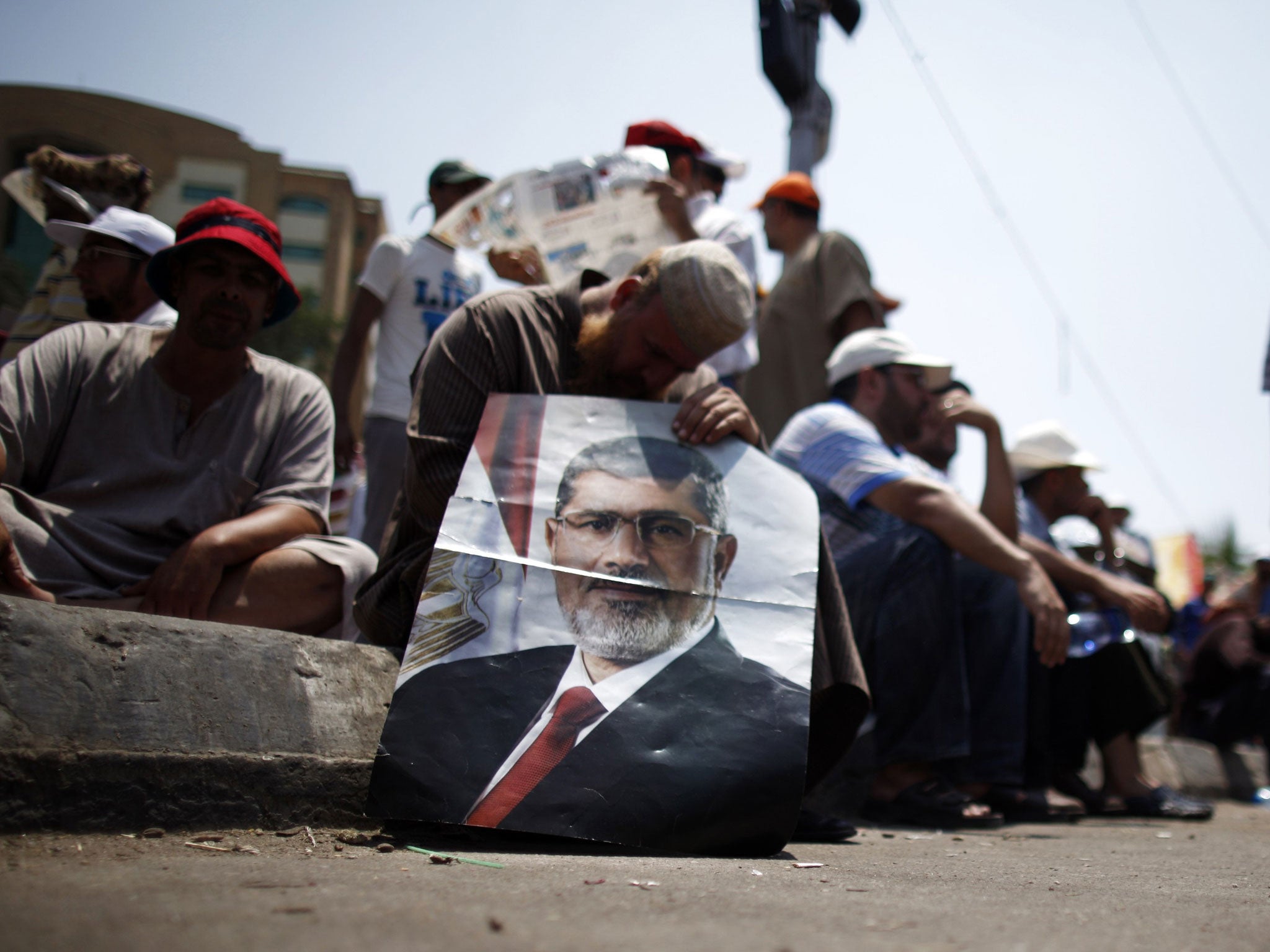 Lost leader: A supporter of the deposed President Morsi displays his image