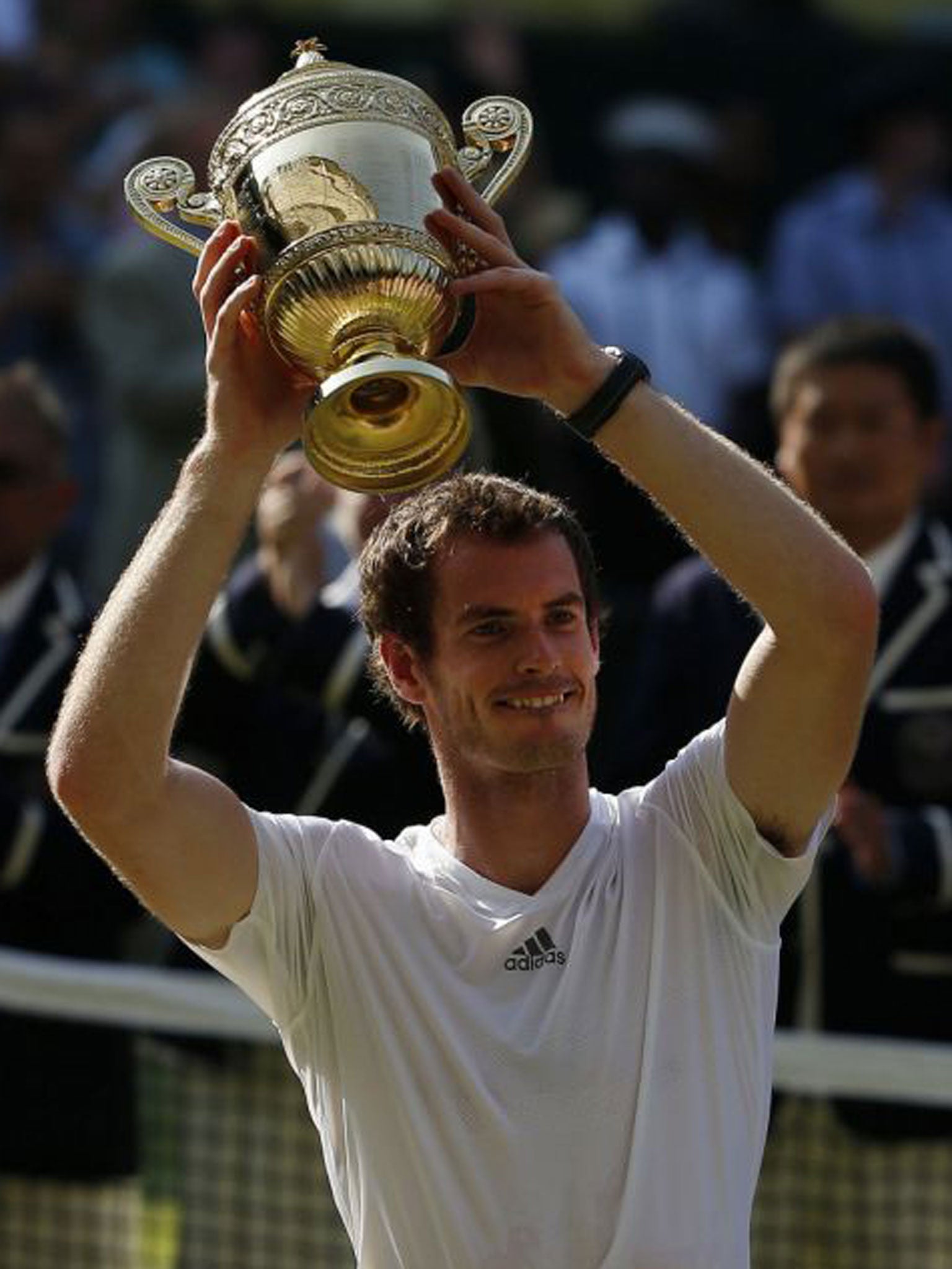 Great Britain's Andy Murray celebrates with the trophy after defeating Serbia's Novak Djokovic in the Men's Final during day thirteen of the Wimbledon Championships