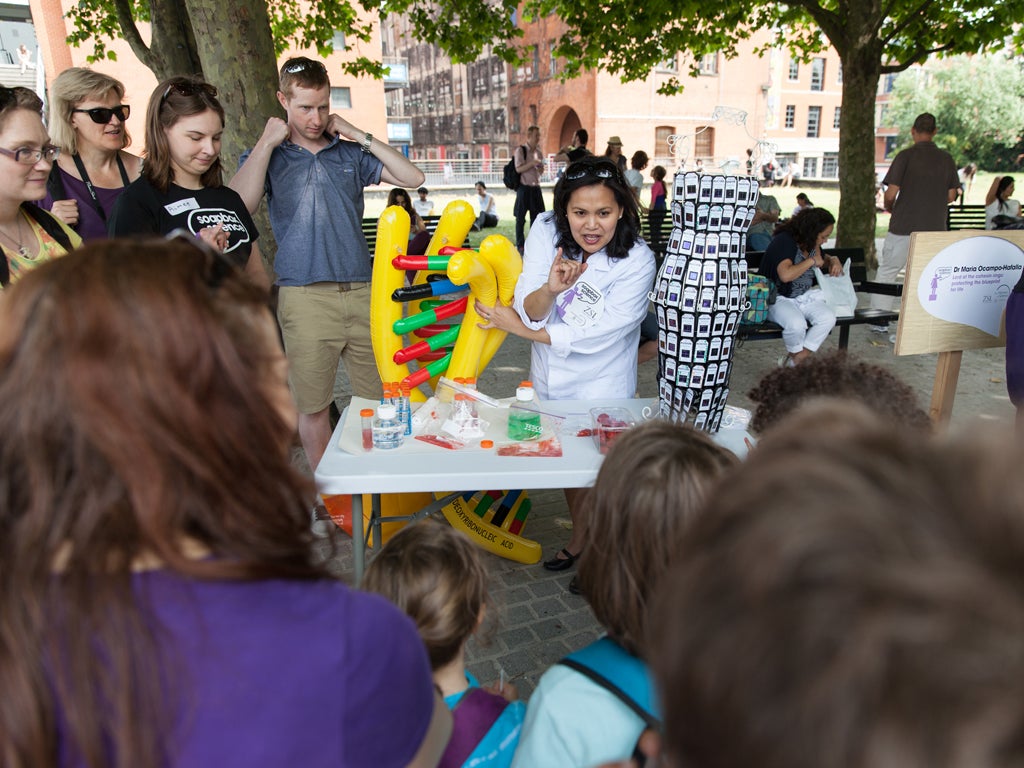 One of the scientists climbs off her soapbox to give a demonstration