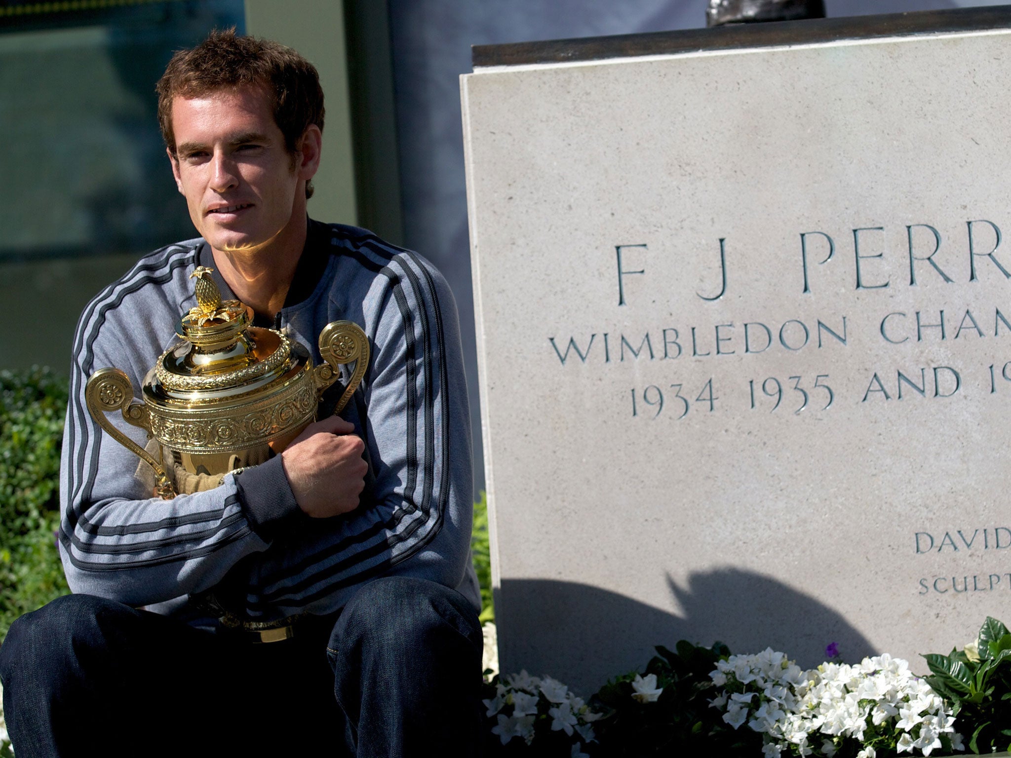 Andy Murray sits beside Fred Perry's SW19 statue