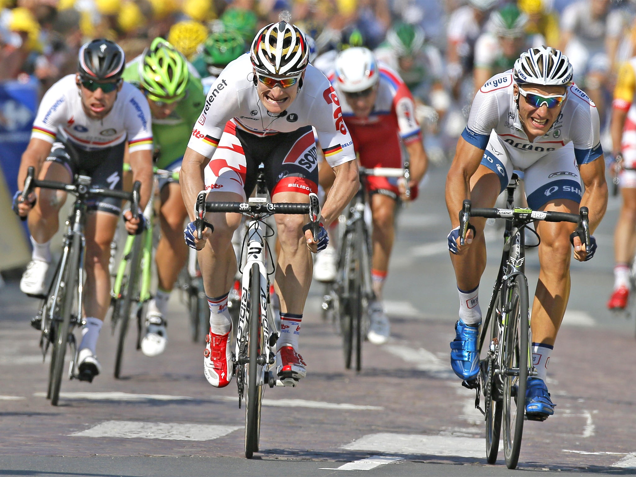 Marcel Kittel, right, crosses the finish line ahead Andre Greipel and Mark Cavendish