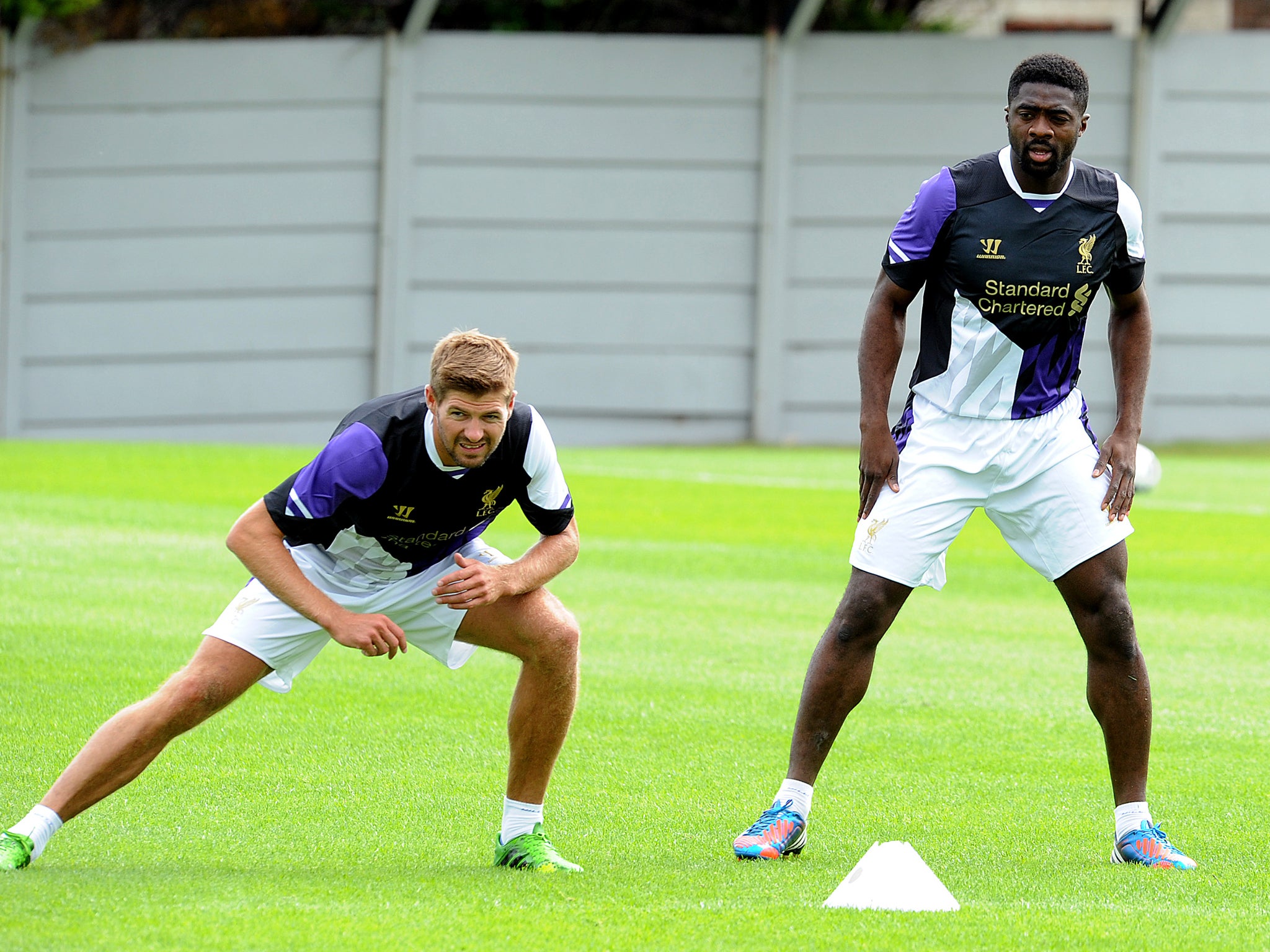 Kolo Toure trains for Liverpool alongside captain Steven Gerrard