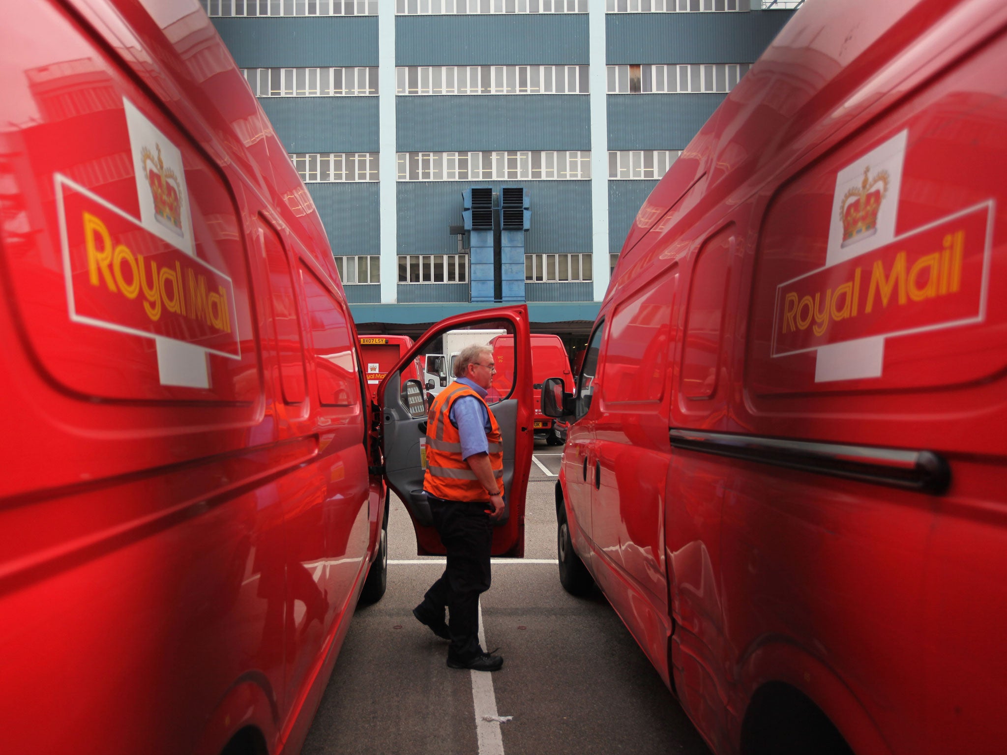 A Royal Mail employee steps out of a delivery van at the Rathbone Place Royal Mail depot in London