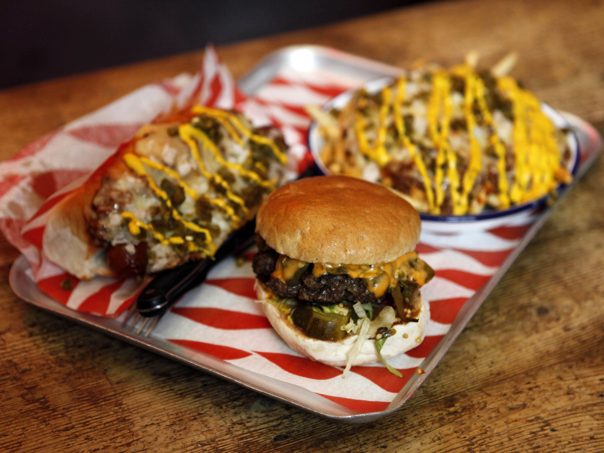 The 'Triple Chilli Challenge' involves a plate of chilli cheese fries, a chilli dog, and a green chilli burger