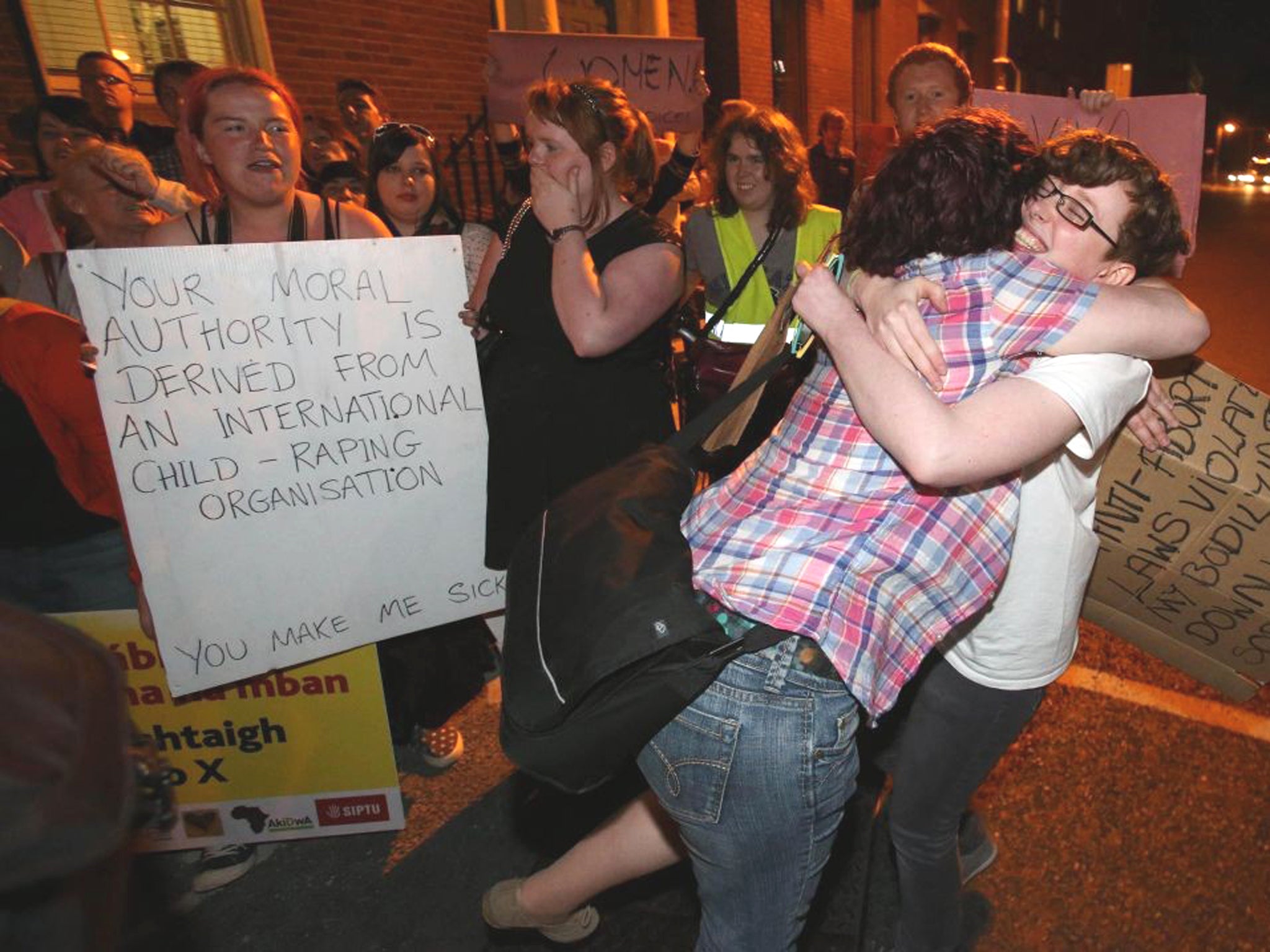 Pro Choice campaigners cheer outside Leinster House in Dublin after the Irish Parliament passed a bill allowing Abortion in limited circumstances in the early hours of the morning