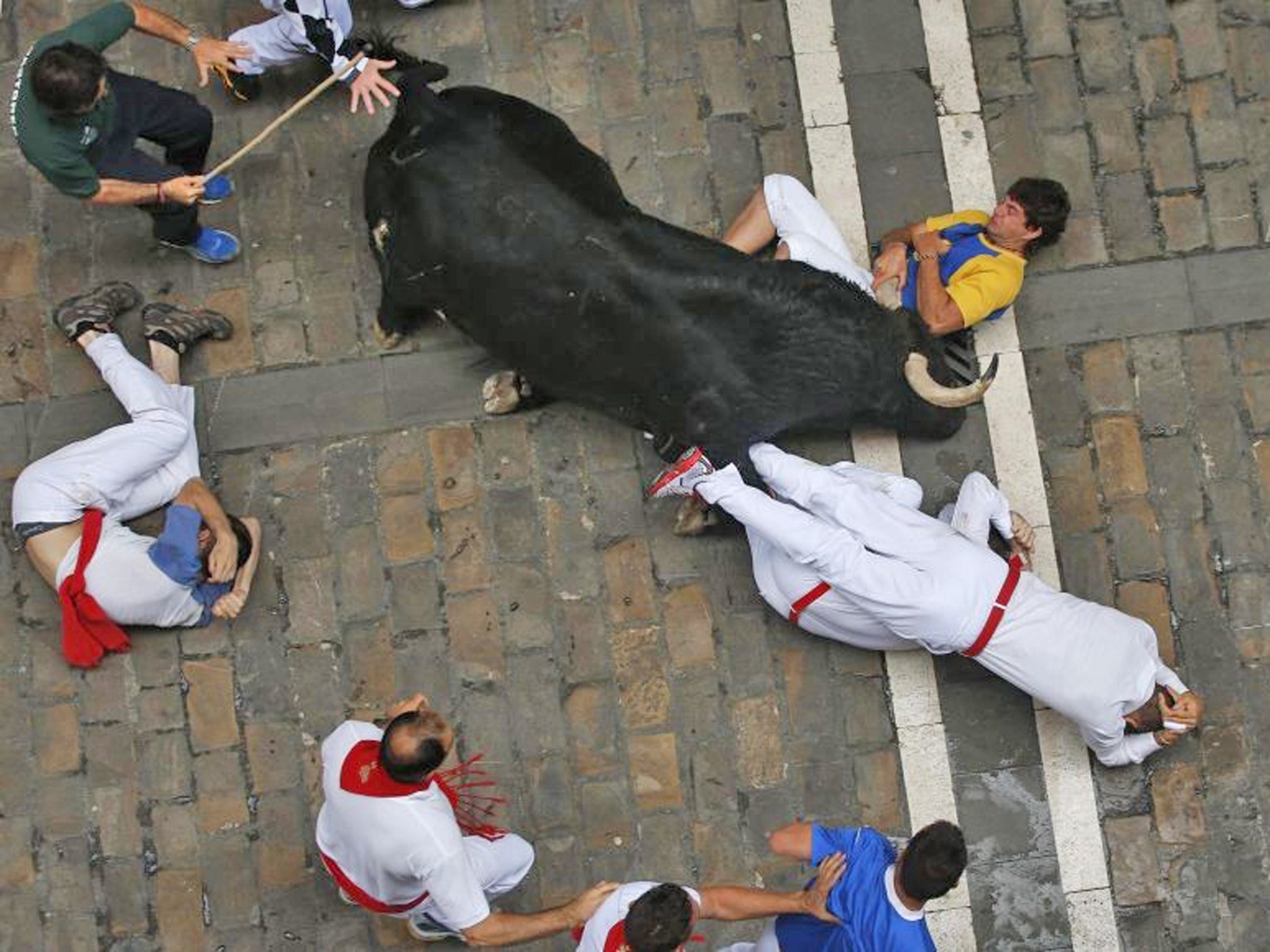 An American and two Spaniards were gored  during a danger-filled bull run at Spain's San Fermin festival