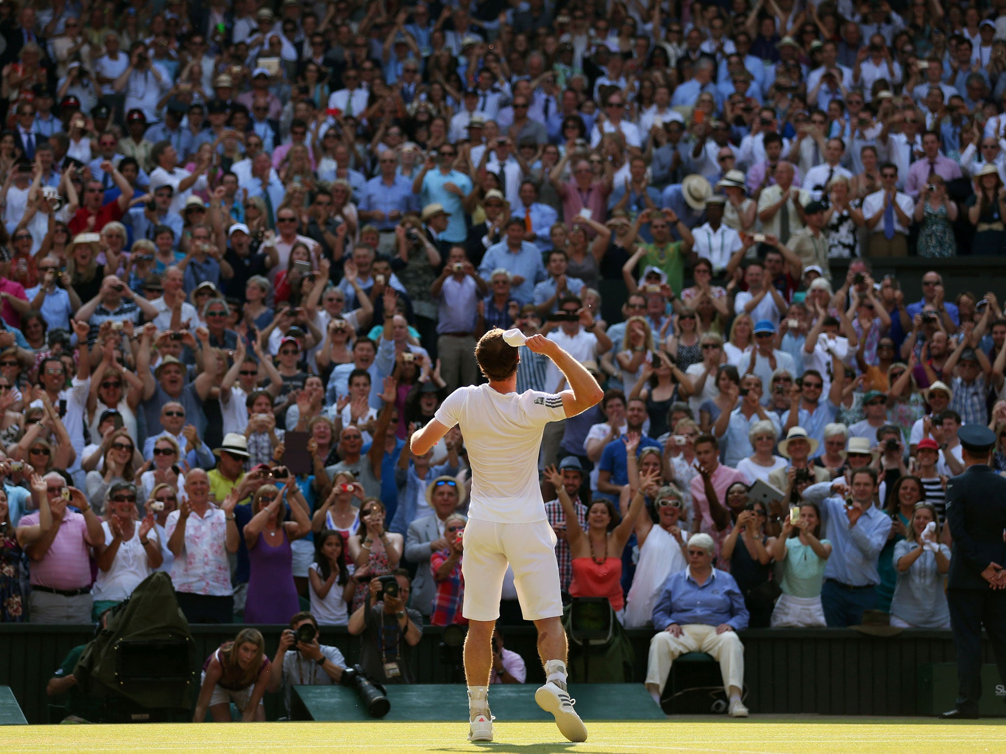 Andy Murray of Great Britain throws his sweatband into the crowd as he celebrates victory during the Gentlemen's Singles Final match against Novak Djokovic of Serbia